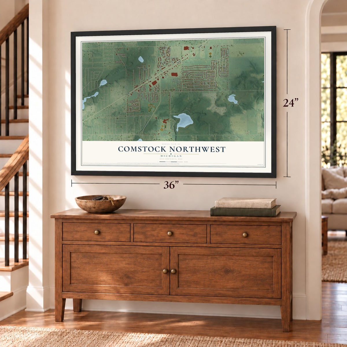 Comstock Northwest, Michigan map, 24 x 36 inch print in a black frame above a dresser by a staircase