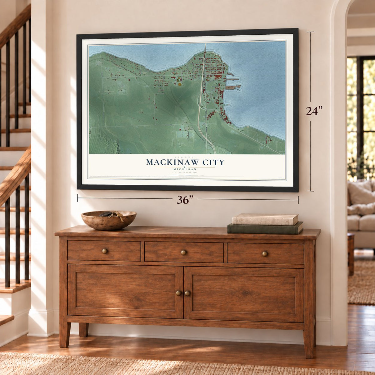 Mackinaw City, Michigan map, 24 x 36 inch print in a black frame above a dresser by a staircase