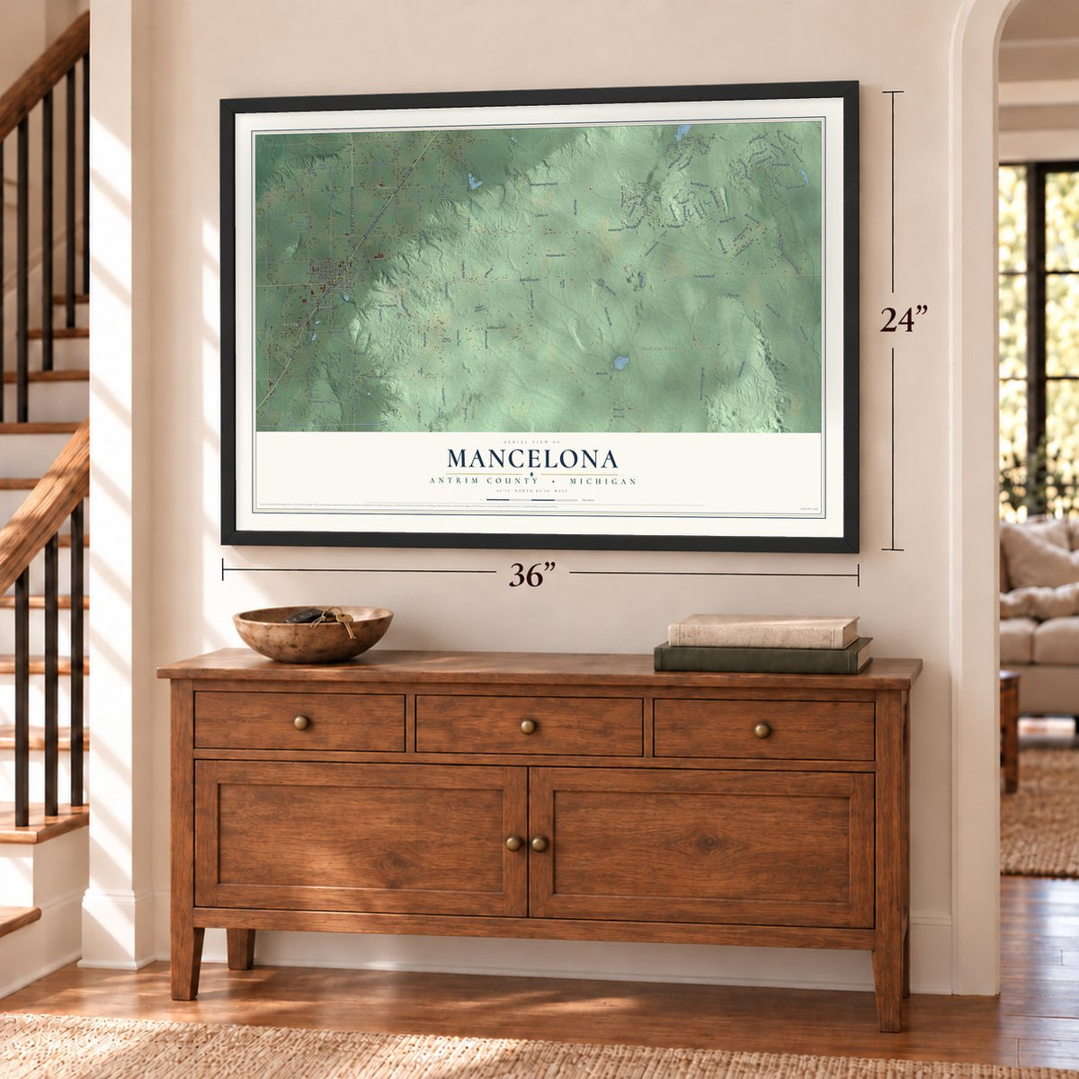 Mancelona, Antrim County, Michigan map, 24 x 36 inch print in a black frame above a dresser by a staircase