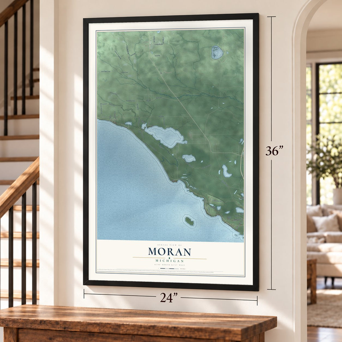 Moran, Michigan map, 24 x 36 inch print in a black frame by a staircase