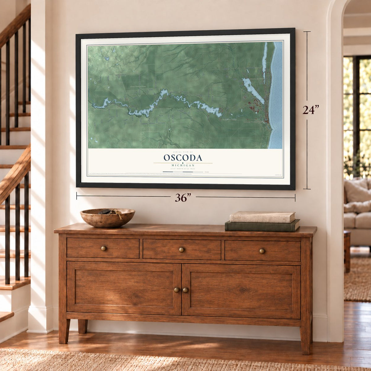 Oscoda, Michigan map, 24 x 36 inch print in a black frame above a dresser by a staircase