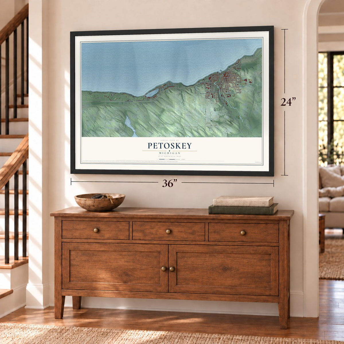 Petoskey, Michigan map, 24 x 36 inch print in a black frame above a dresser by a staircase