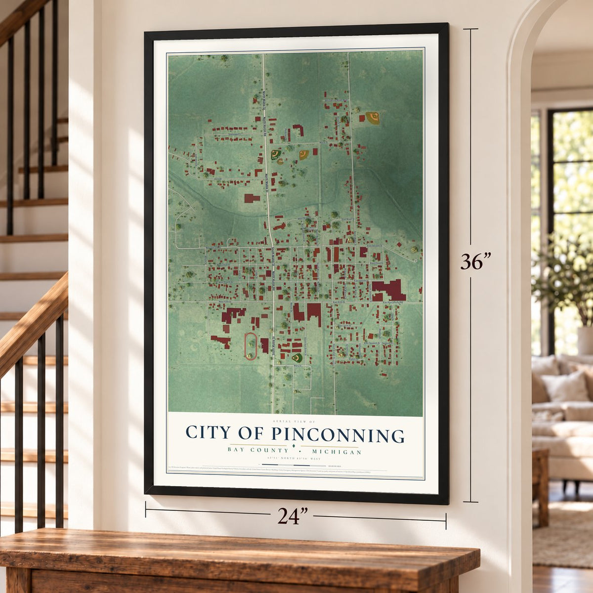 Pinconning, Michigan map, 24 x 36 inch print in a black frame by a staircase