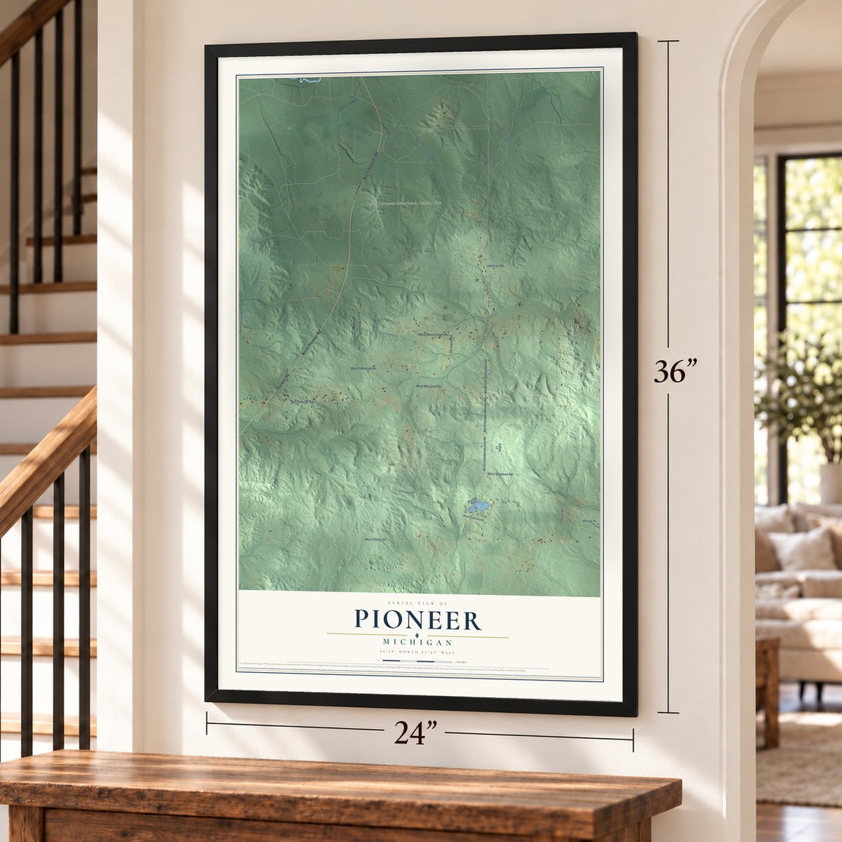 Pioneer, Michigan map, 24 x 36 inch print in a black frame by a staircase