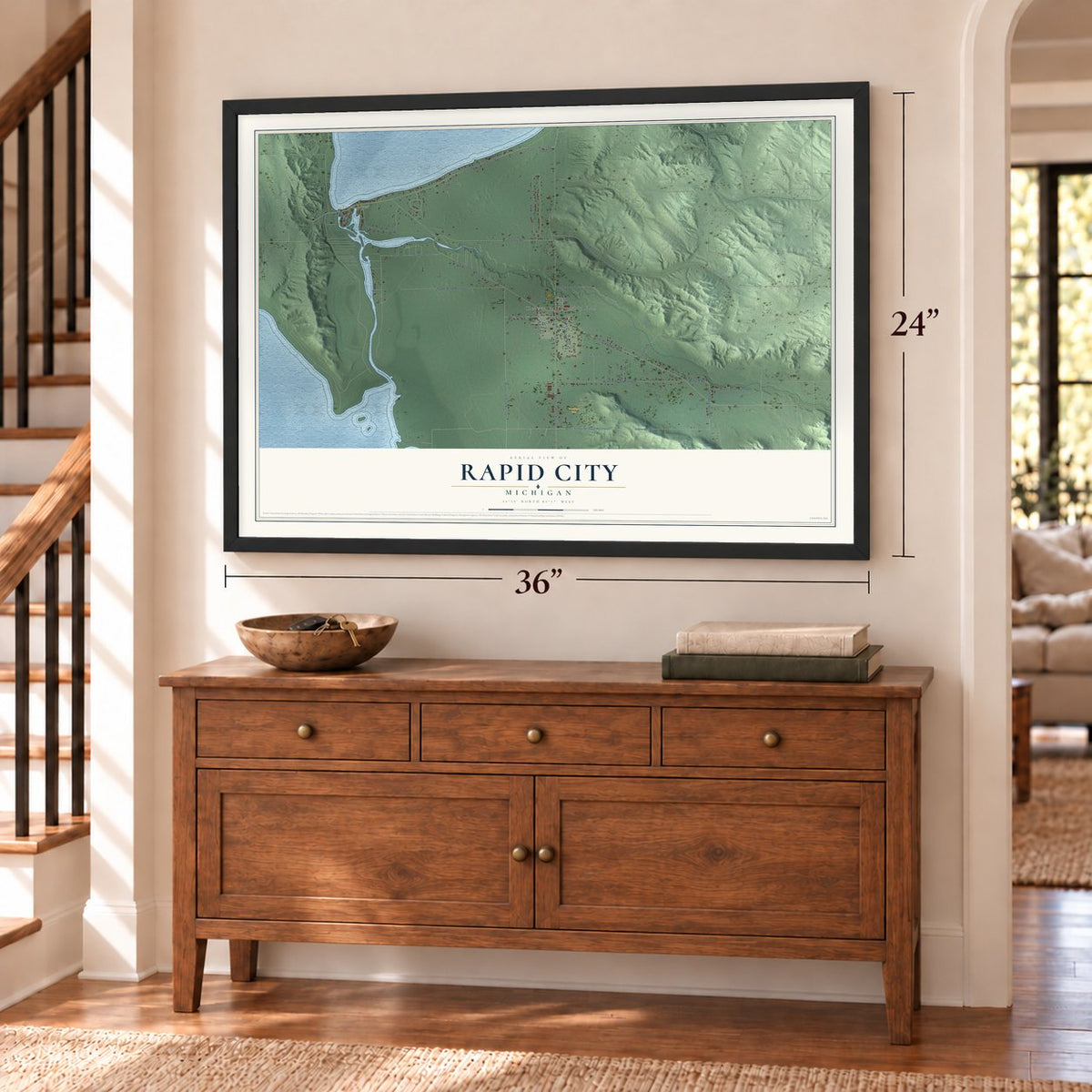 Rapid City, Michigan map, 24 x 36 inch print in a black frame above a dresser by a staircase