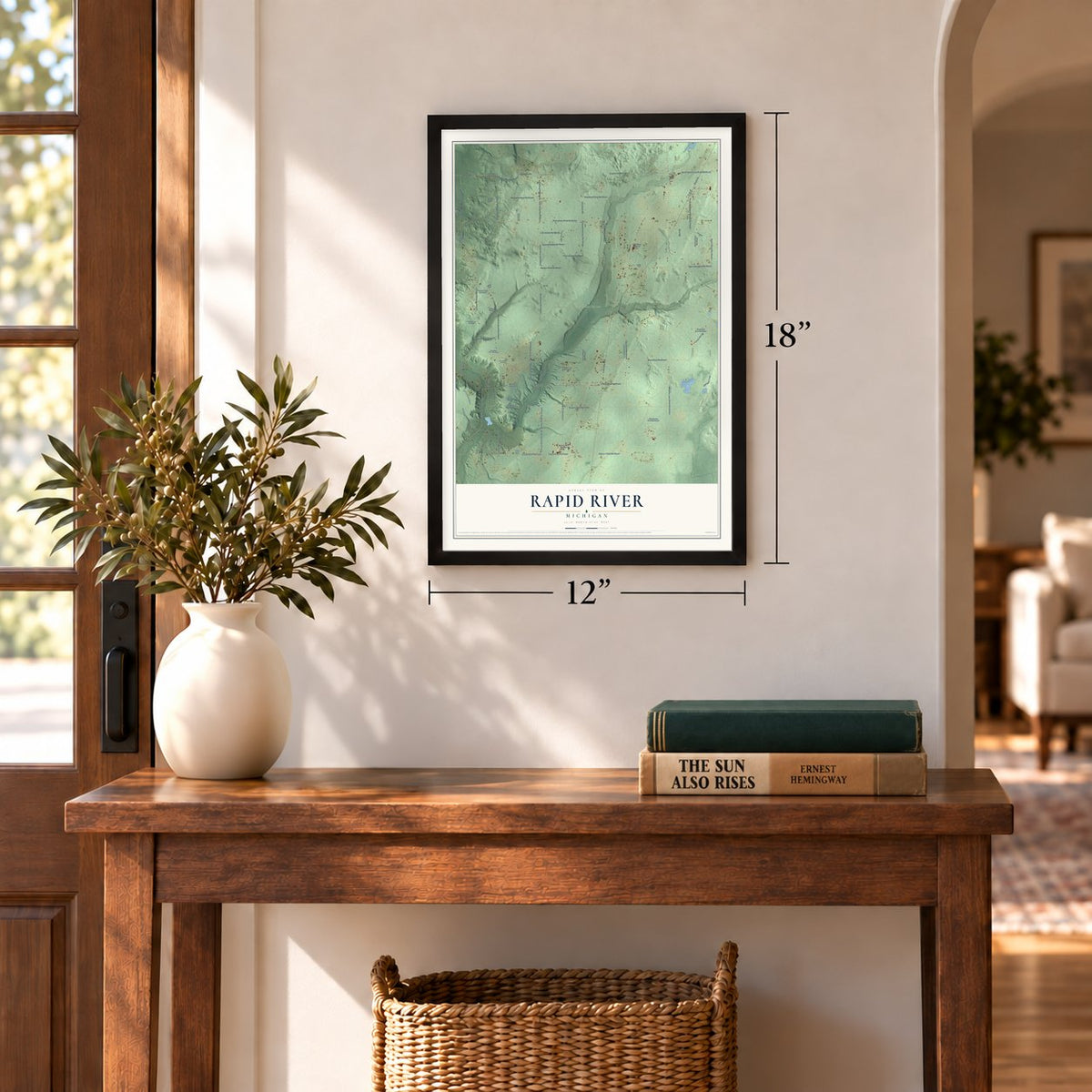 Rapid River, Michigan map, 12 x 18 inch print in a black frame in an entryway