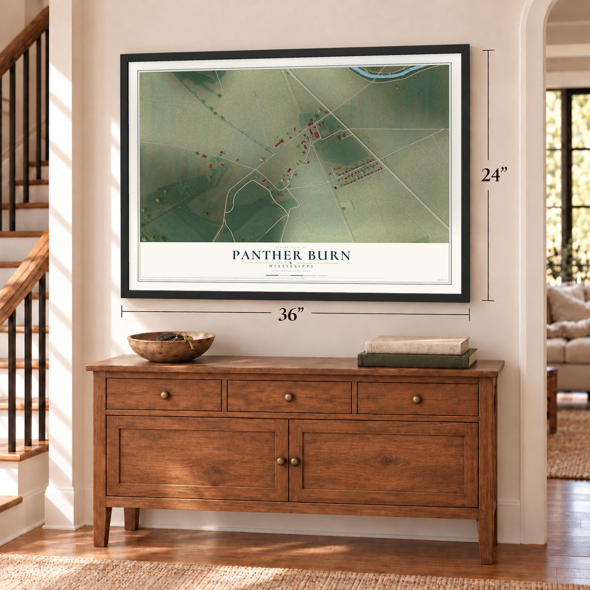 Panther Burn, Mississippi map, 24 x 36 inch print in a black frame above a dresser by a staircase