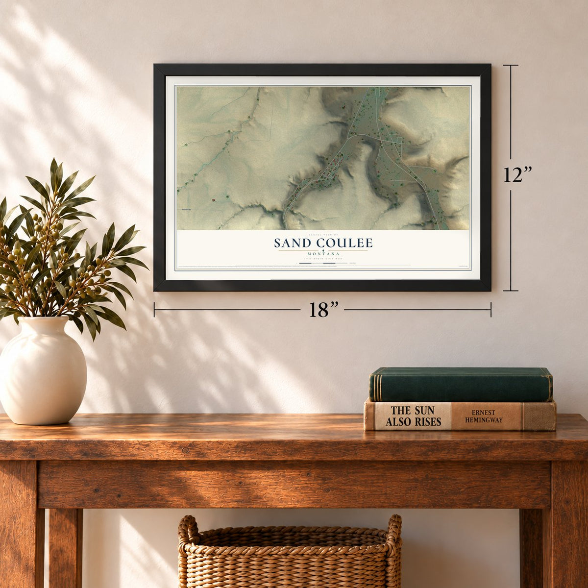 Sand Coulee, Montana map, 12 x 18 inch print in a black frame in an entryway