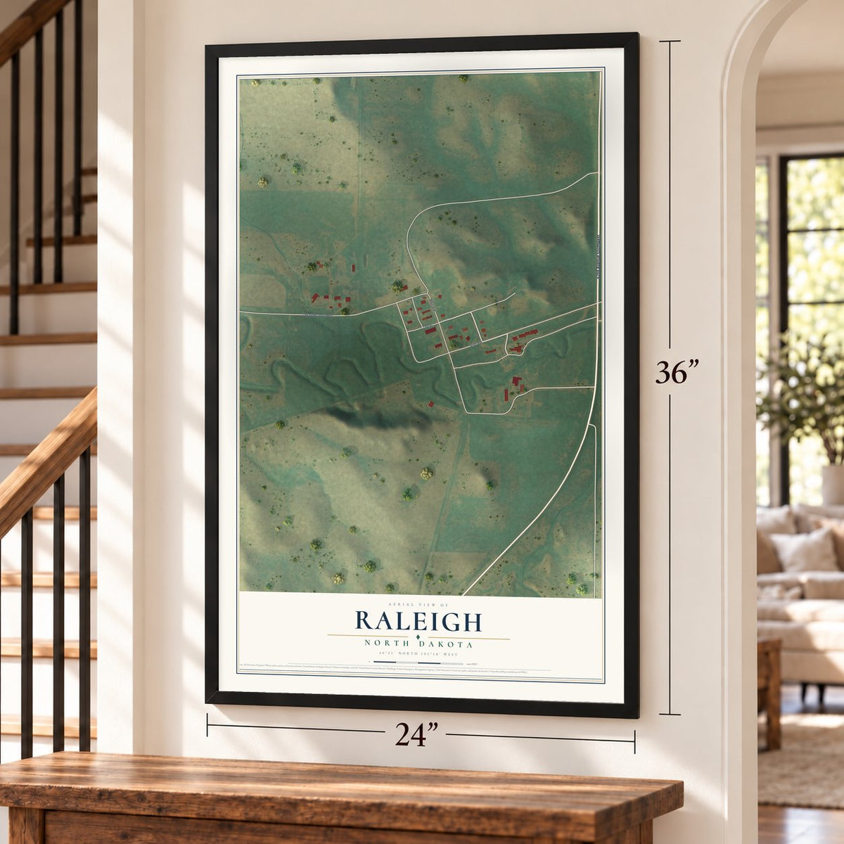 Raleigh, North Dakota map, 24 x 36 inch print in a black frame by a staircase