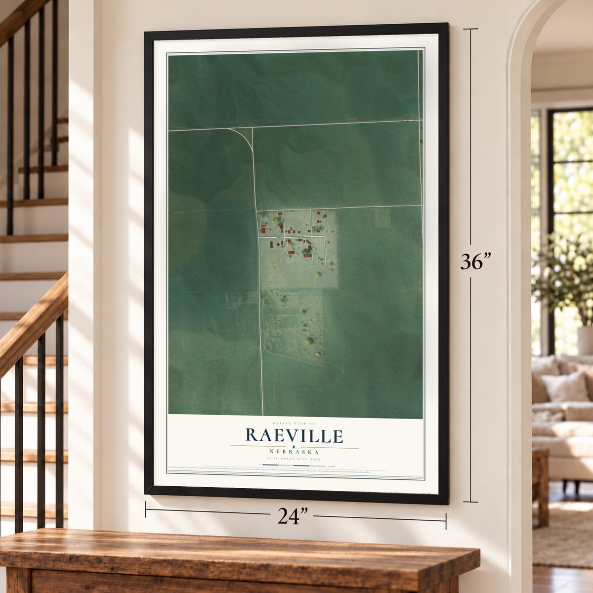 Raeville, Nebraska map, 24 x 36 inch print in a black frame by a staircase