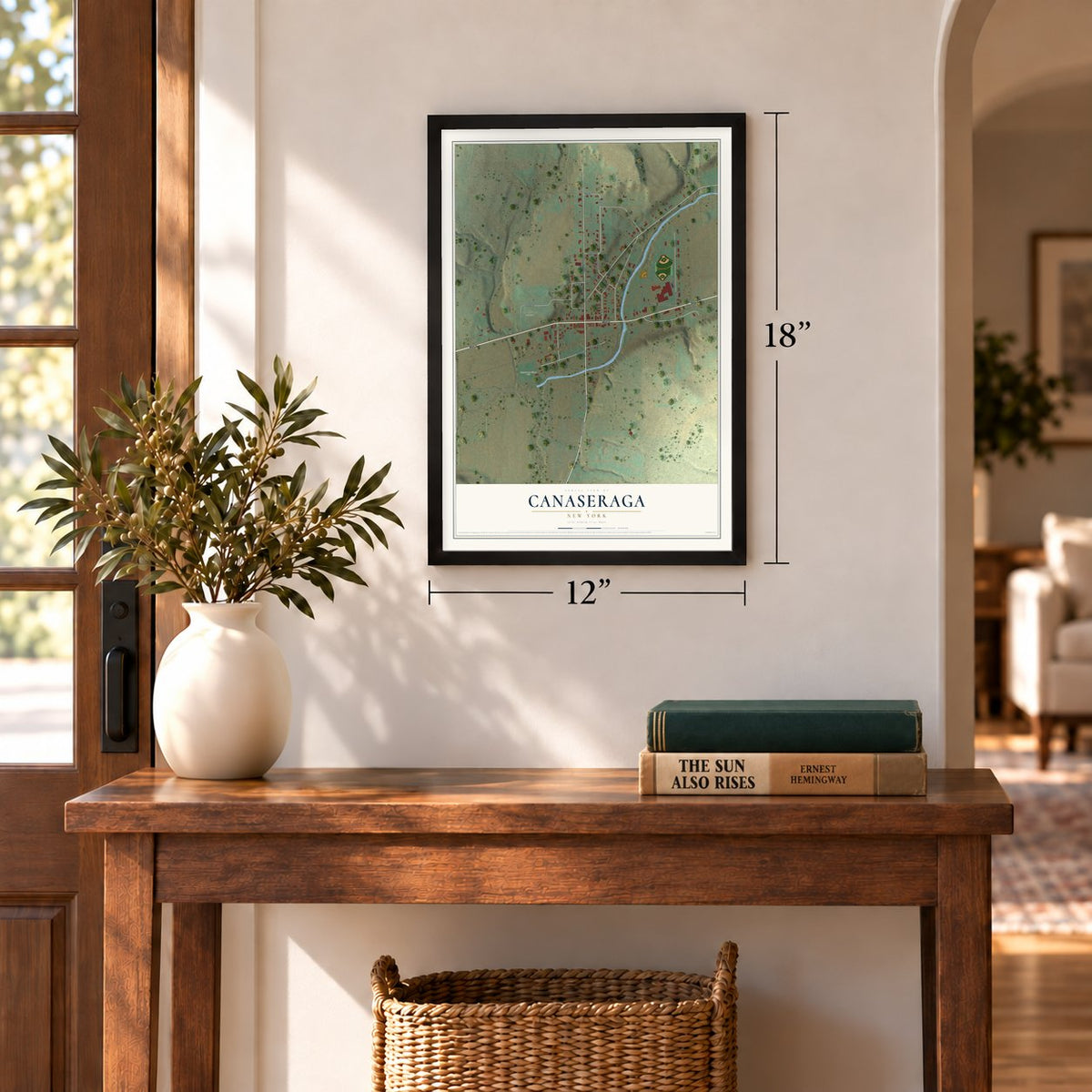 Canaseraga, New York map, 12 x 18 inch print in a black frame in an entryway