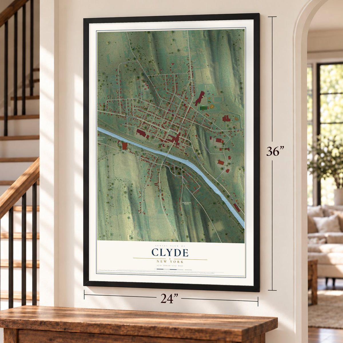 Clyde, New York map, 24 x 36 inch print in a black frame by a staircase