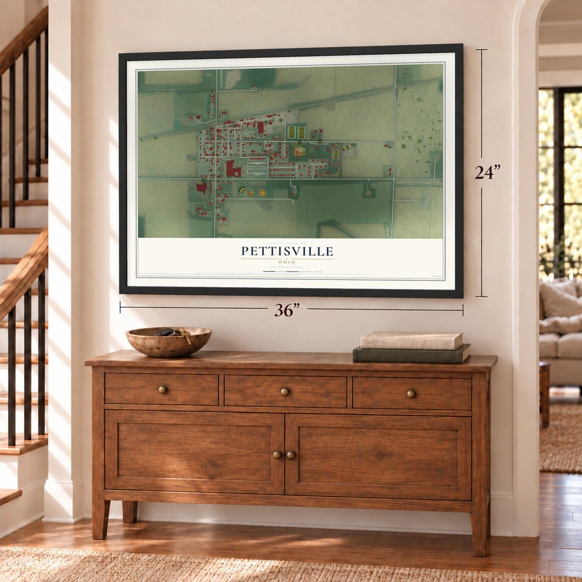 Pettisville, Ohio map, 24 x 36 inch print in a black frame above a dresser by a staircase