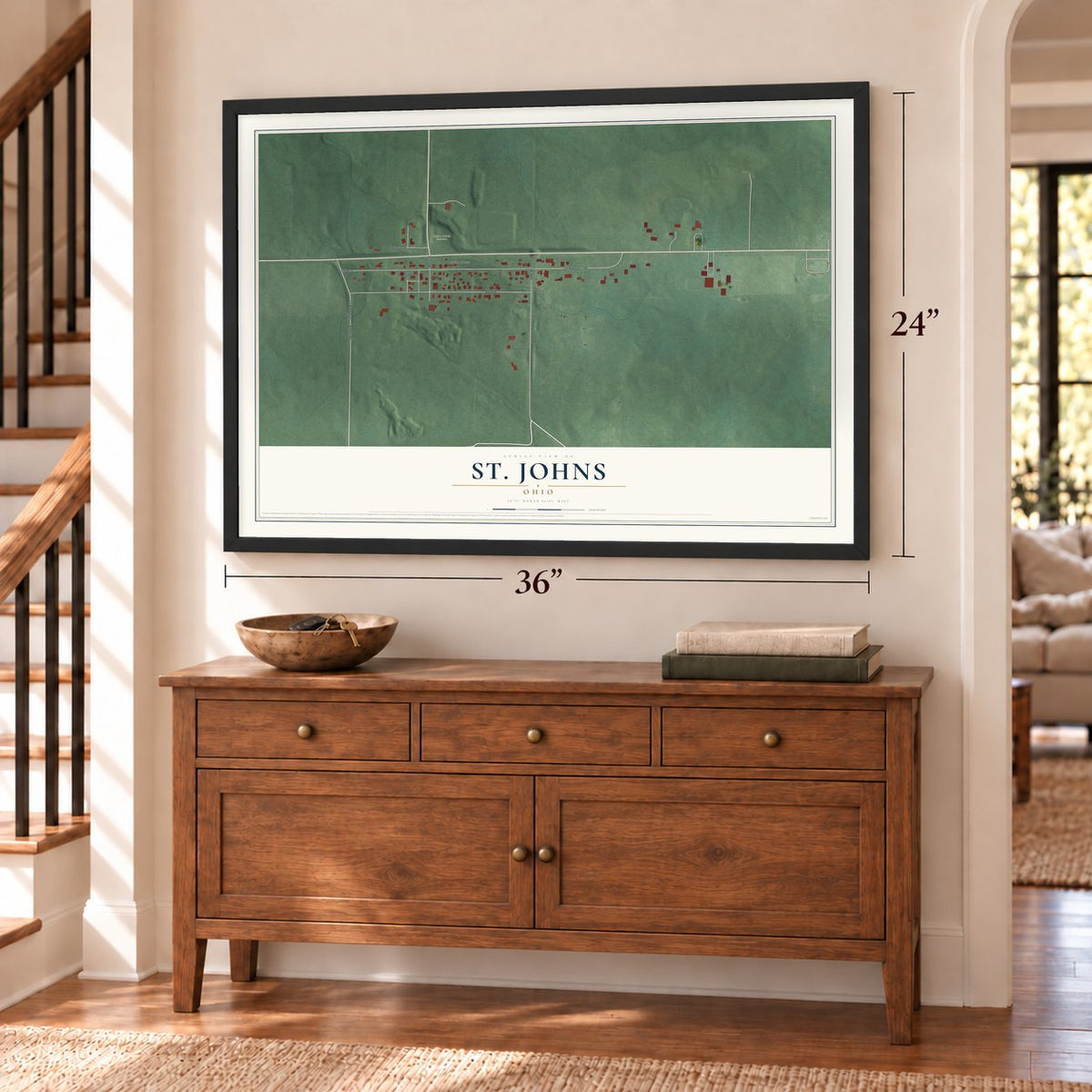 St. Johns, Ohio map, 24 x 36 inch print in a black frame above a dresser by a staircase