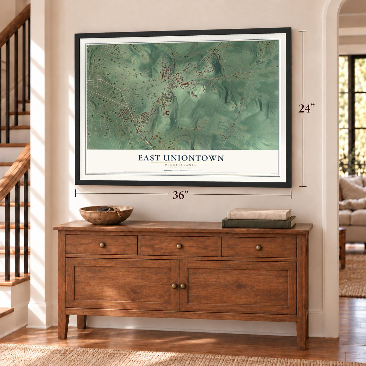 East Uniontown, Pennsylvania map, 24 x 36 inch print in a black frame above a dresser by a staircase