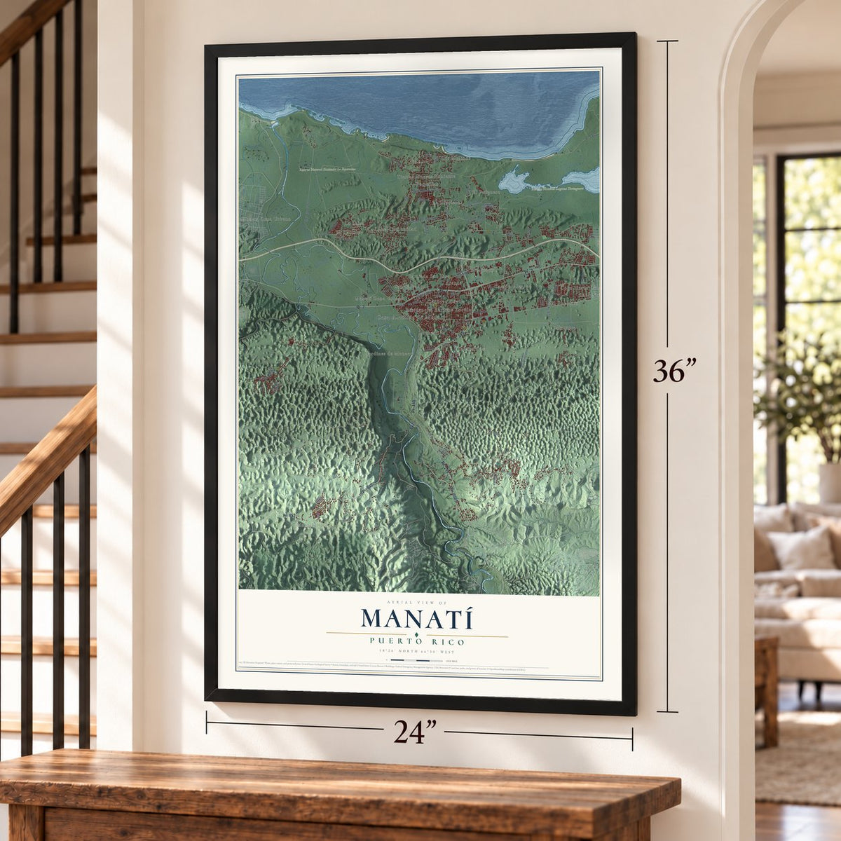 Manatí, Puerto Rico map, 24 x 36 inch print in a black frame by a staircase