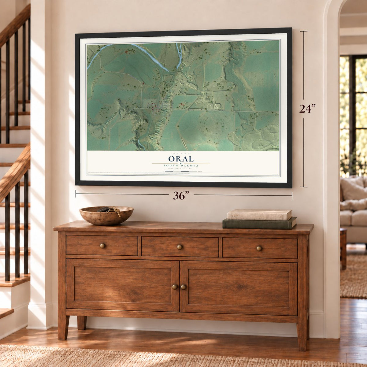 Oral, South Dakota map, 24 x 36 inch print in a black frame above a dresser by a staircase