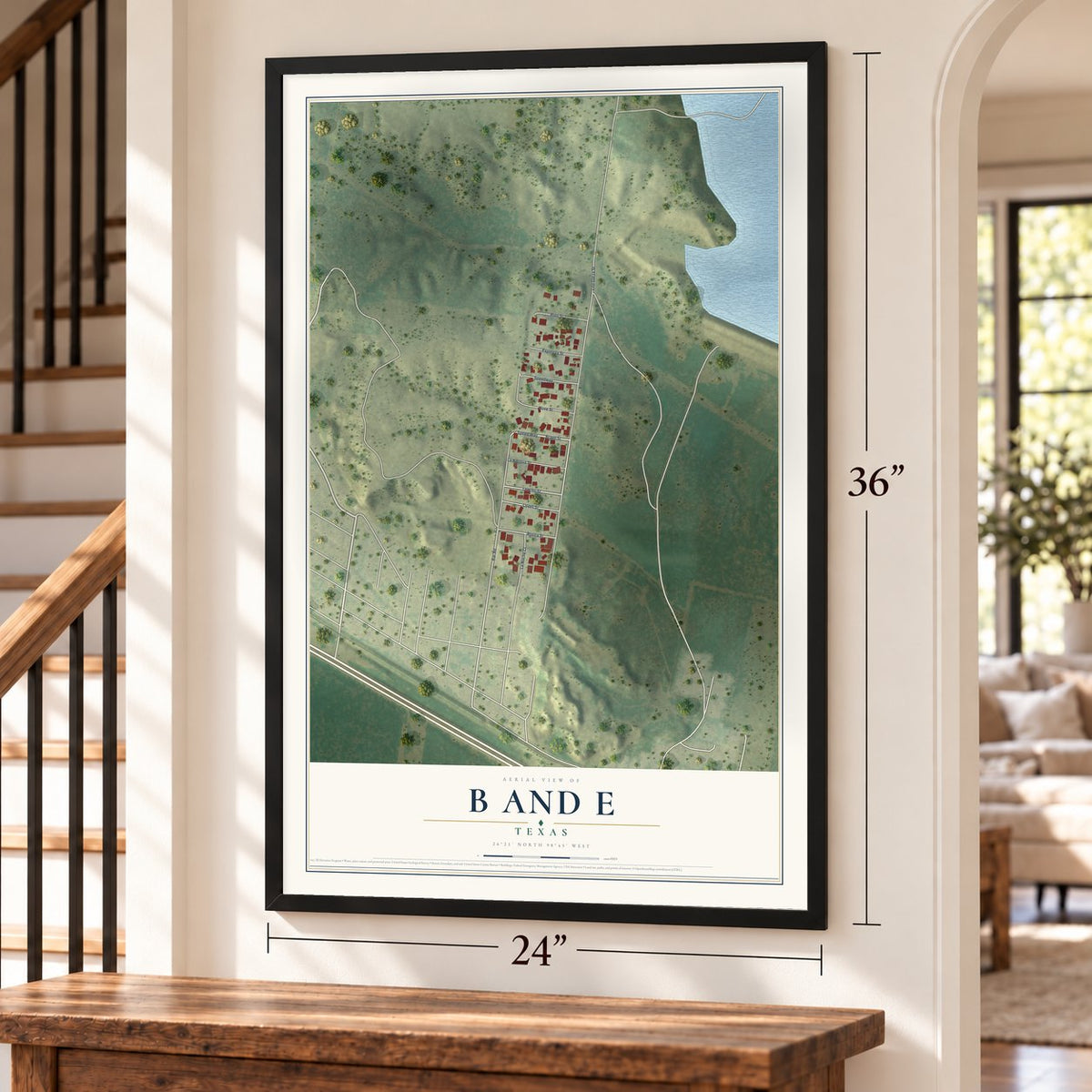 B and E, Texas map, 24 x 36 inch print in a black frame by a staircase