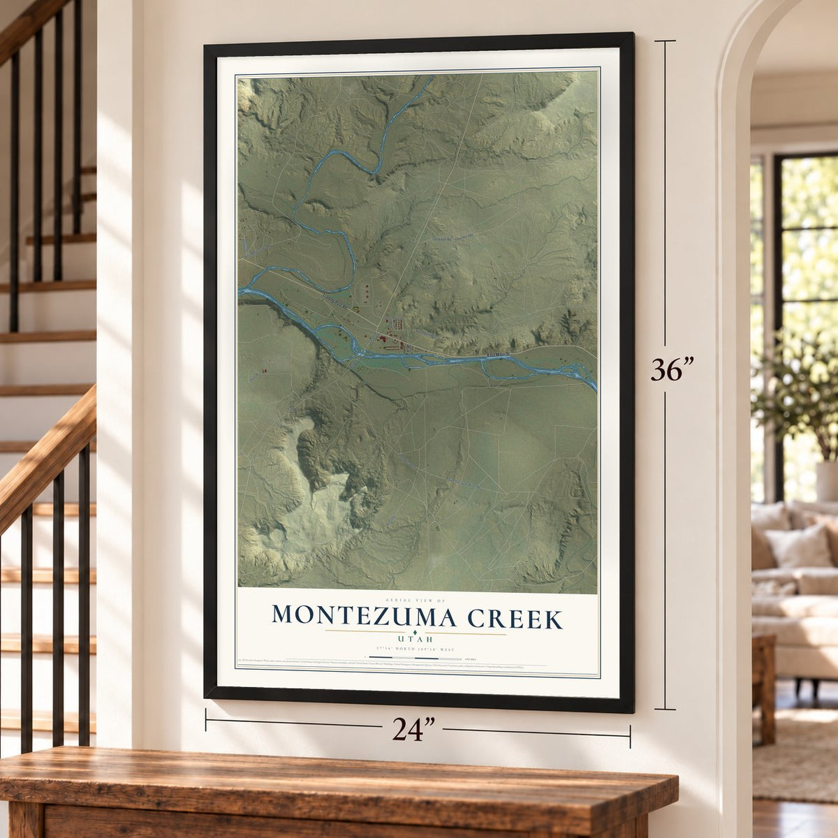 Montezuma Creek, Utah map, 24 x 36 inch print in a black frame by a staircase