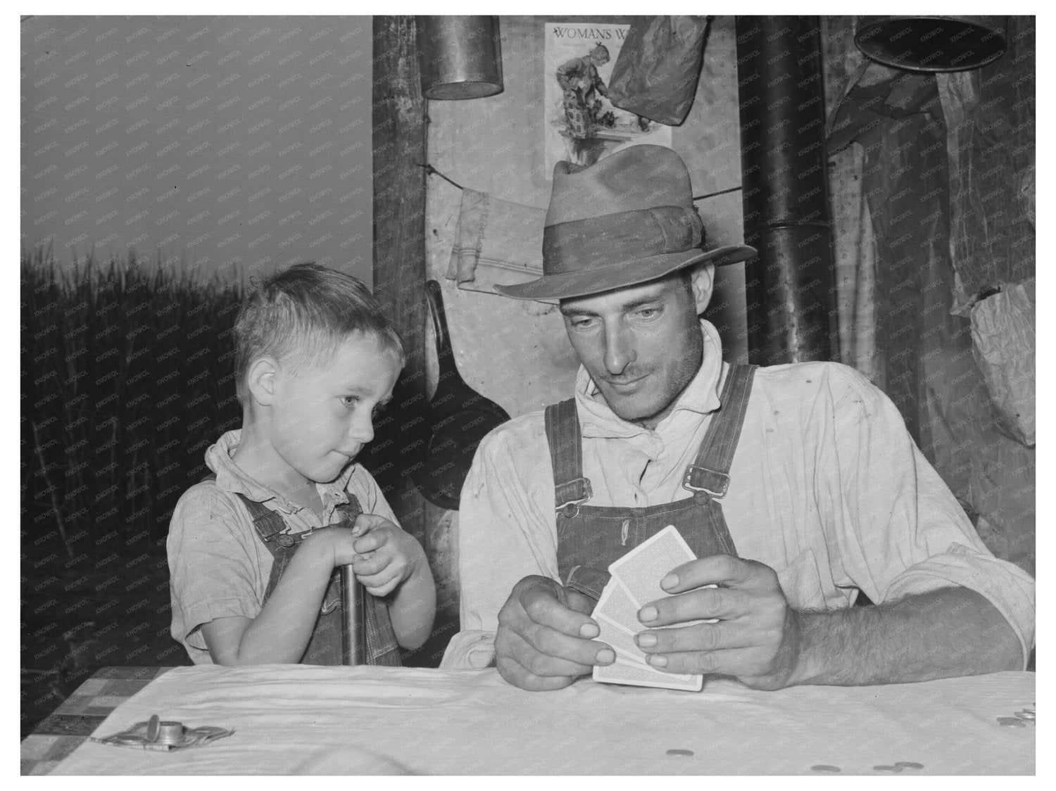 1938 Day Laborer and Son Playing Poker in Louisiana - Available at KNOWOL