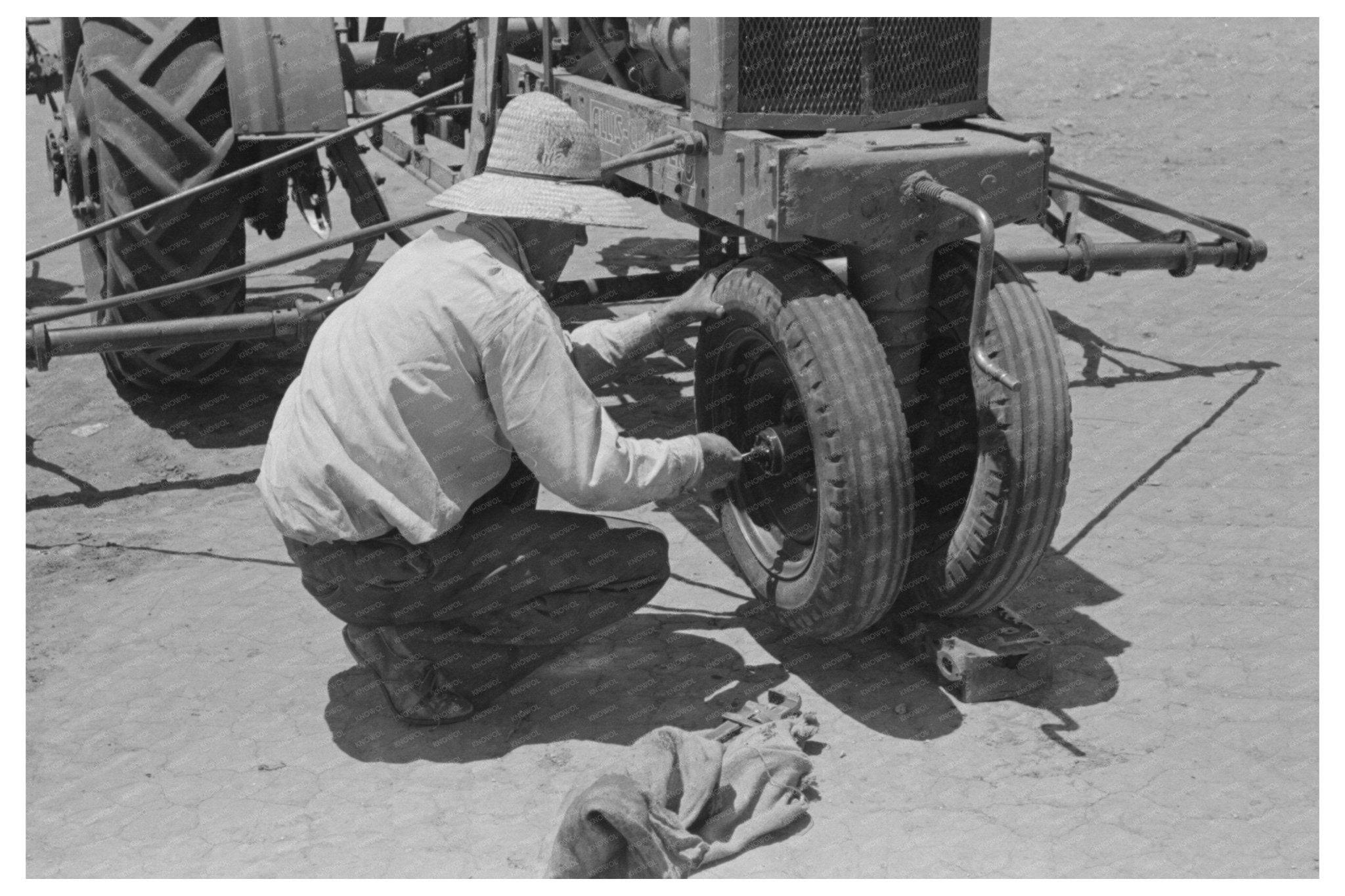 1939 Laborer Tightening Tractor Bearing at Texas Farm - Available at KNOWOL