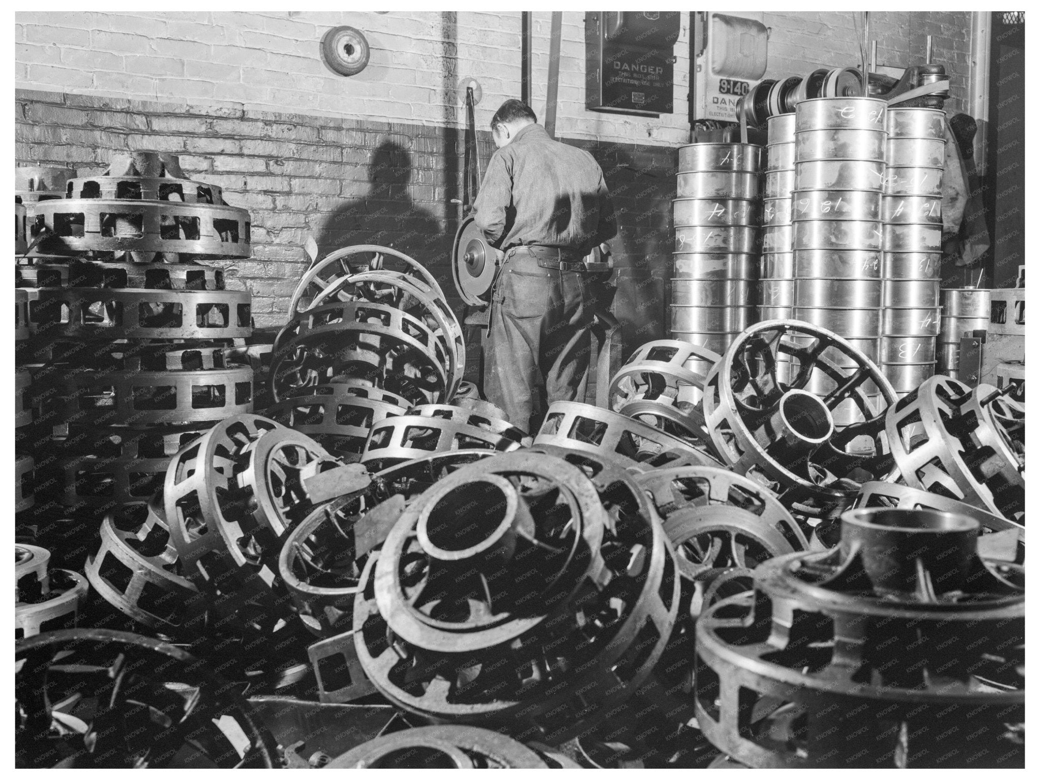 1941 Worker Inspects Wheel Castings for Army Vehicles - Available at KNOWOL