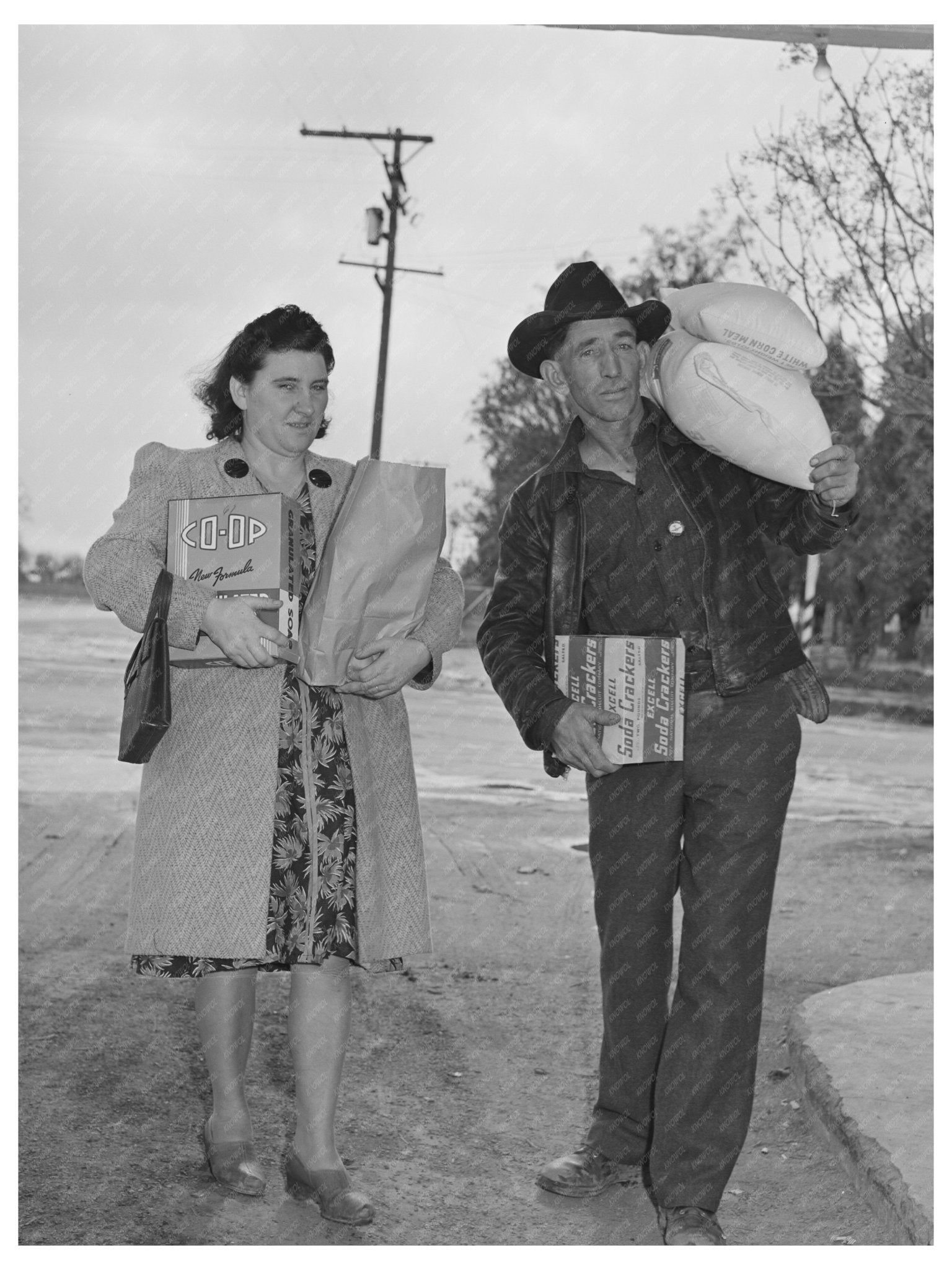 1942 Farmer and Wife Carrying Groceries in Tulare County - Available at KNOWOL