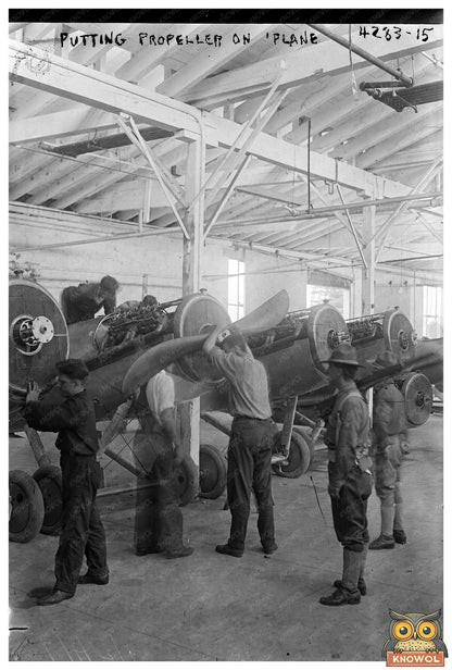 1917 Moment: Worker Fitting Propeller on Vintage Plane