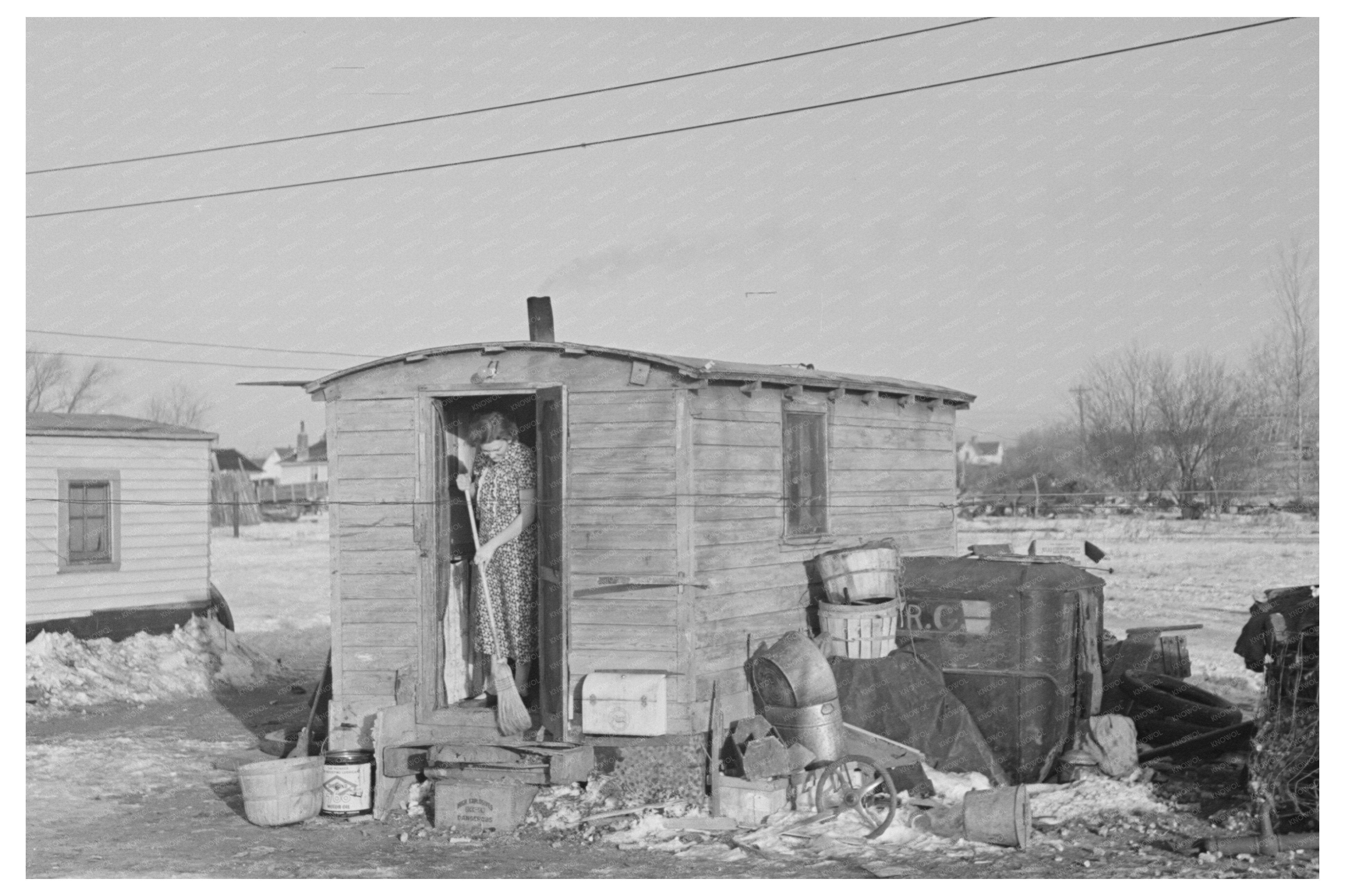 Mrs. Charles Benning Sweeping Steps in Shantytown 1936