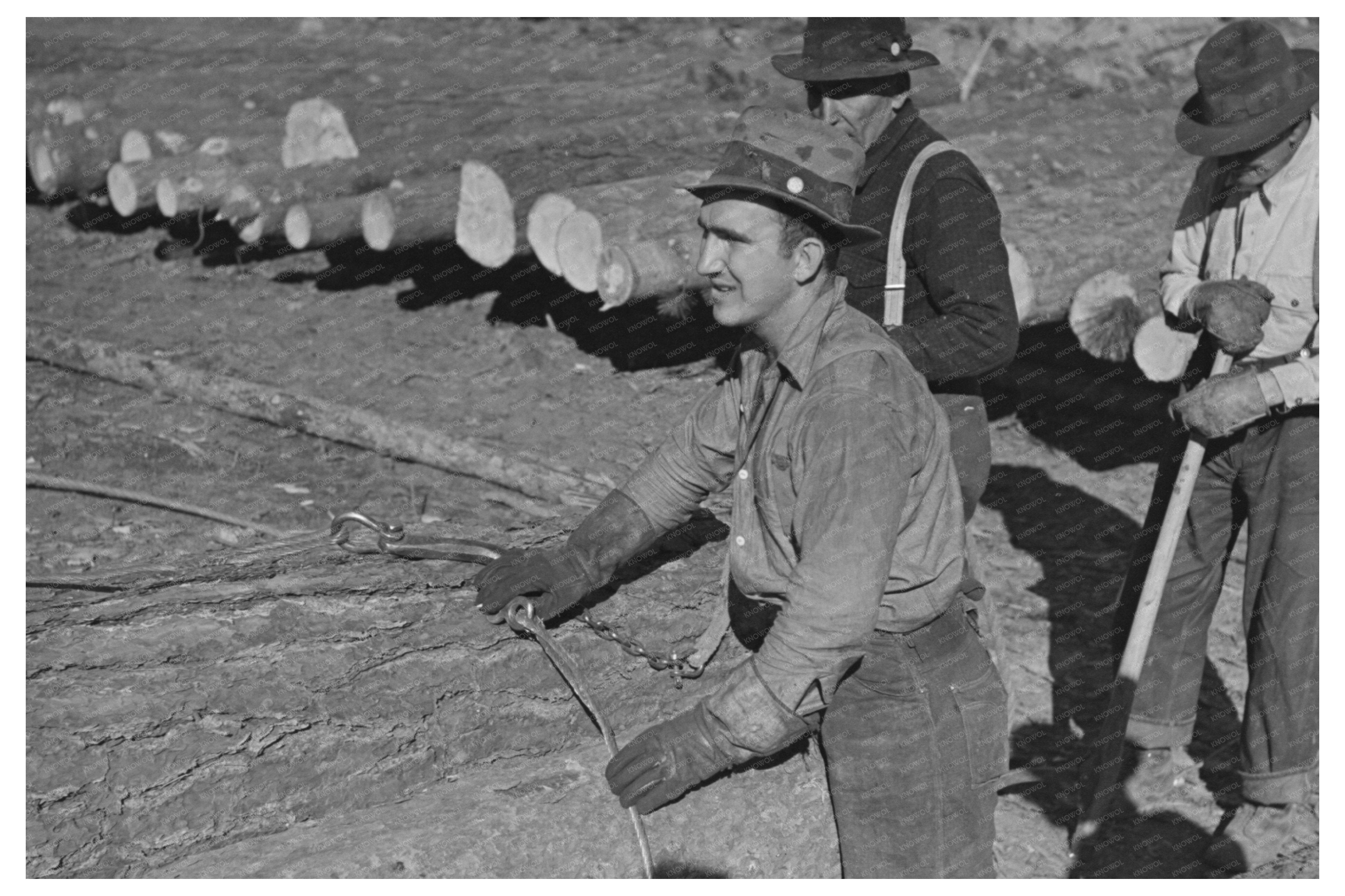 Lumberjack Adjusting Loading Chain at Minnesota Camp 1937