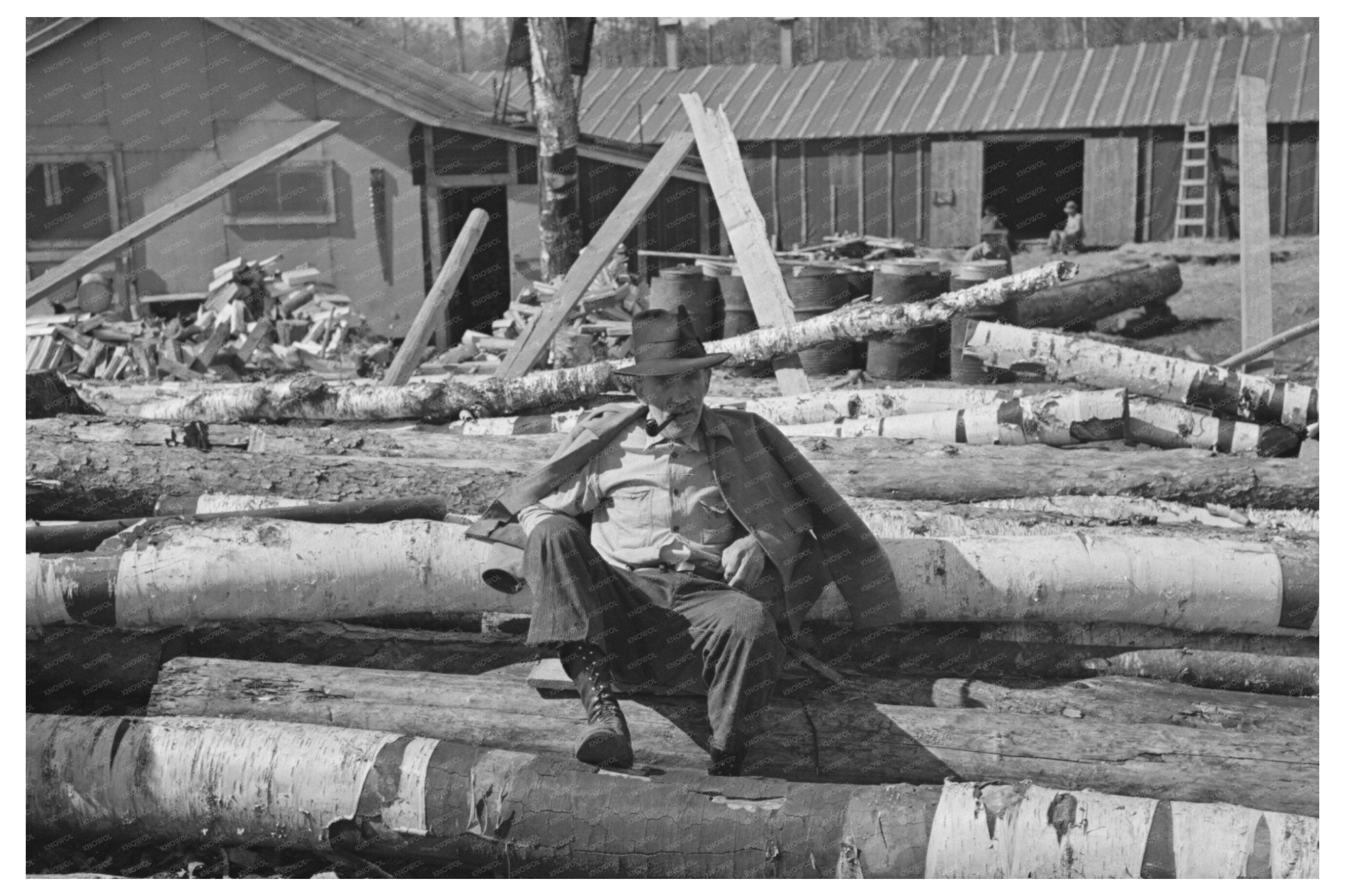 Lumberjack Resting on Logs Effie Minnesota 1937