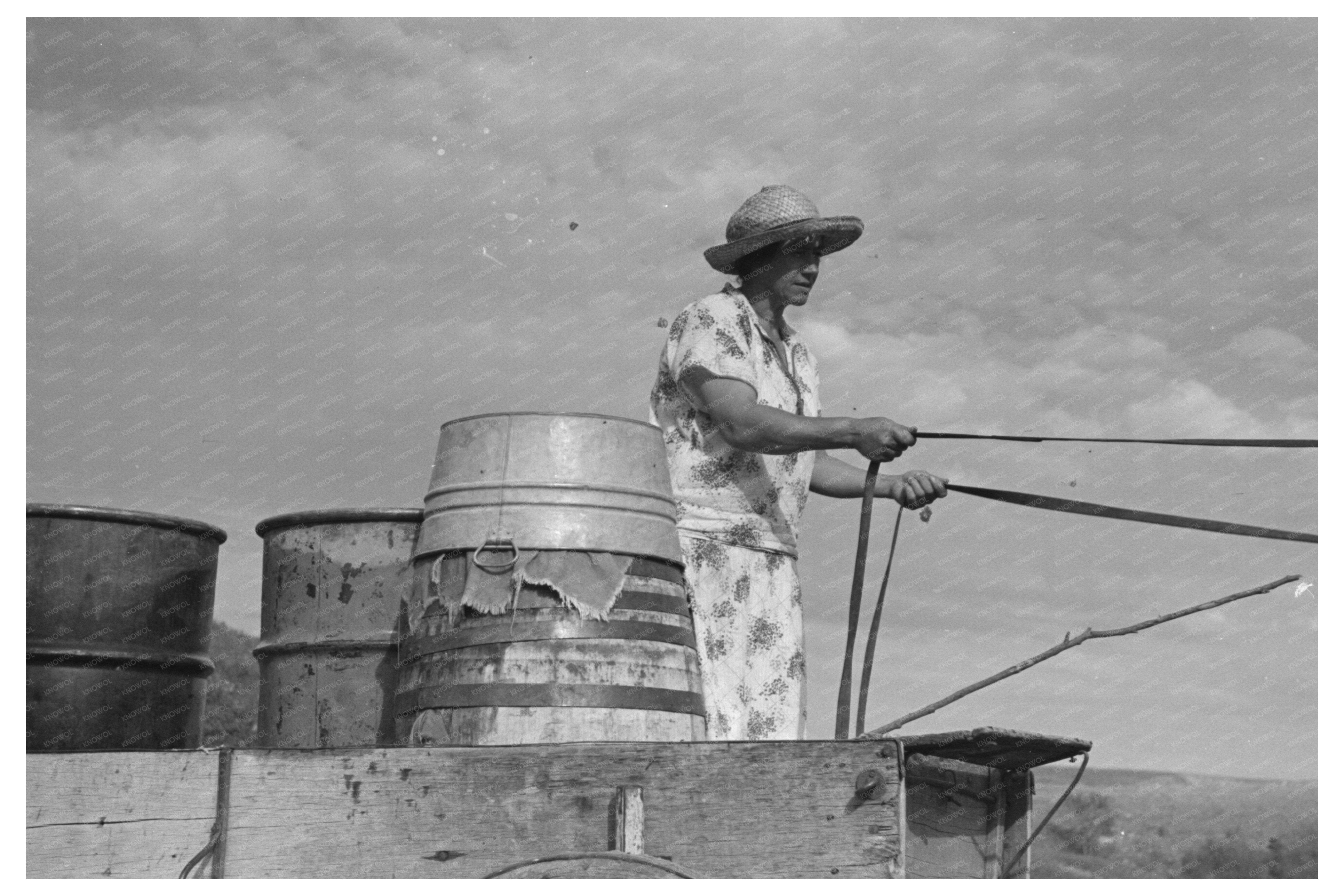 Mrs. Olie Thompson Driving Home with Water Barrels 1937