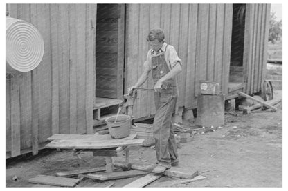 Young Boy Pumping Water in New Madrid County 1938