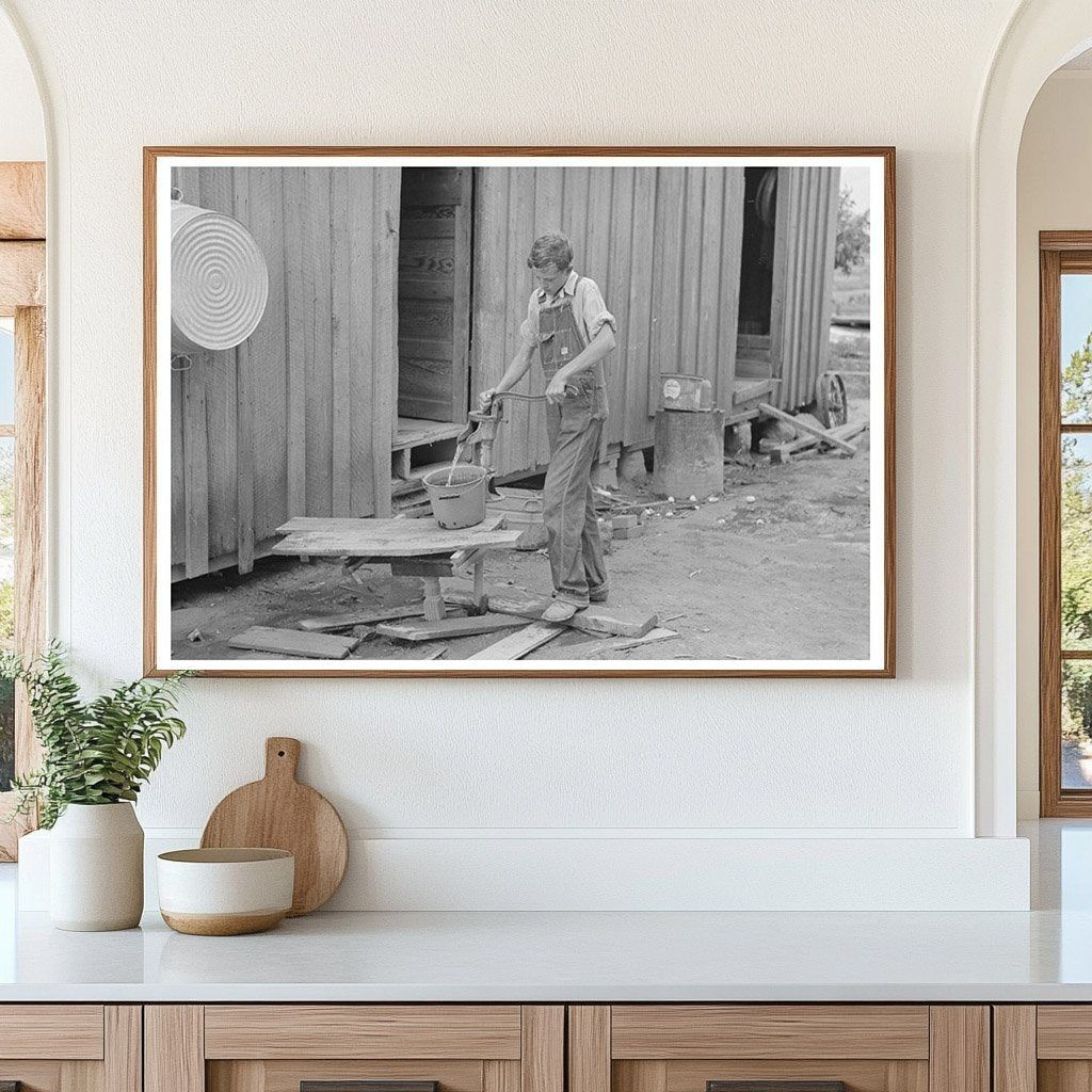 Young Boy Pumping Water in New Madrid County 1938