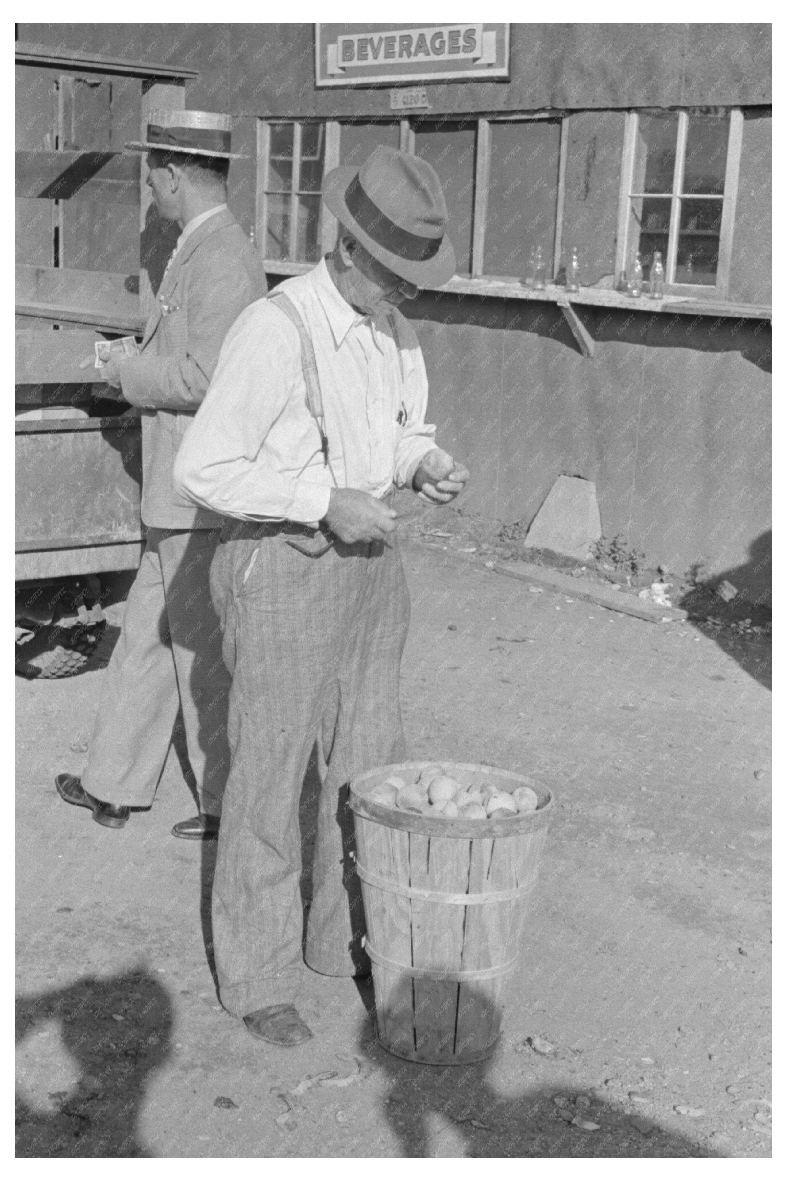 Farmer Eating Peach at Sikeston Auction May 1938