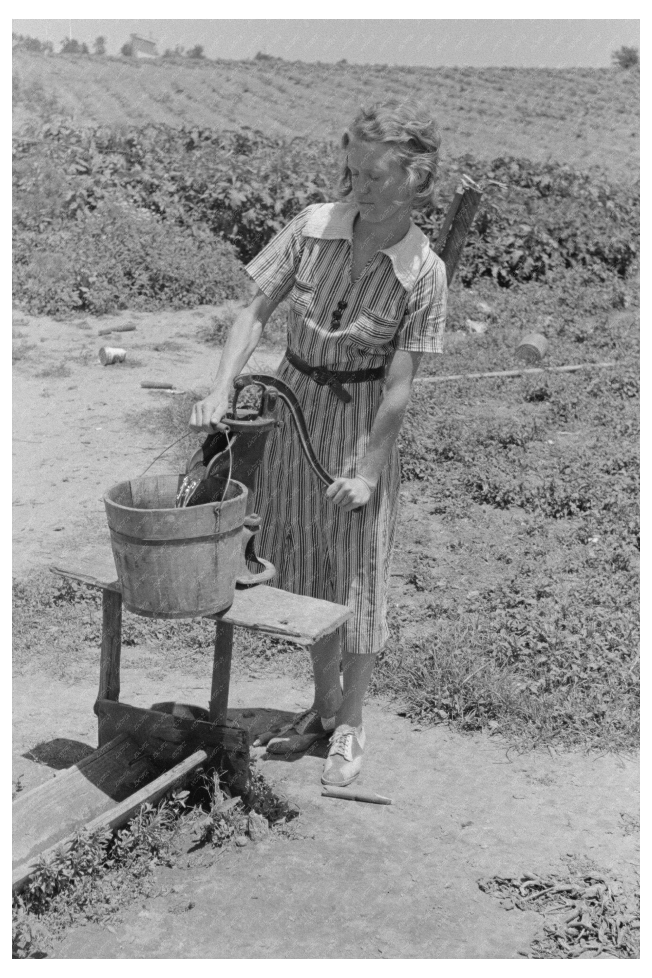 Daughter of Sharecropper Pumps Water May 1938 Missouri