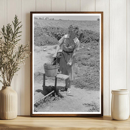 Daughter of Sharecropper Pumps Water May 1938 Missouri