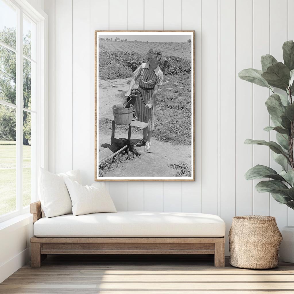 Daughter of Sharecropper Pumps Water May 1938 Missouri