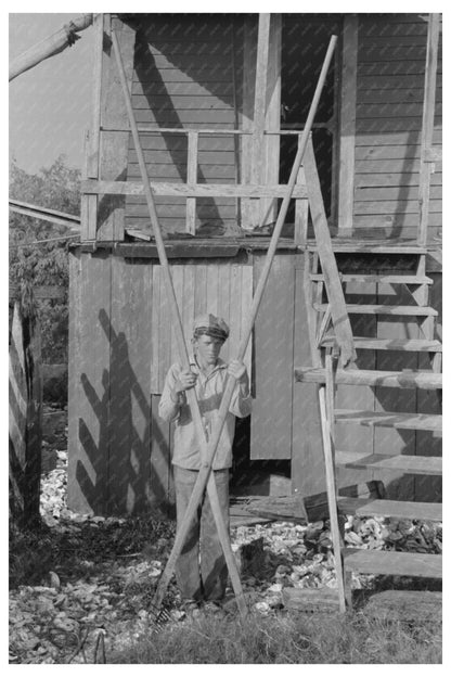 Boy Using Oyster Rake in Olga Louisiana 1938