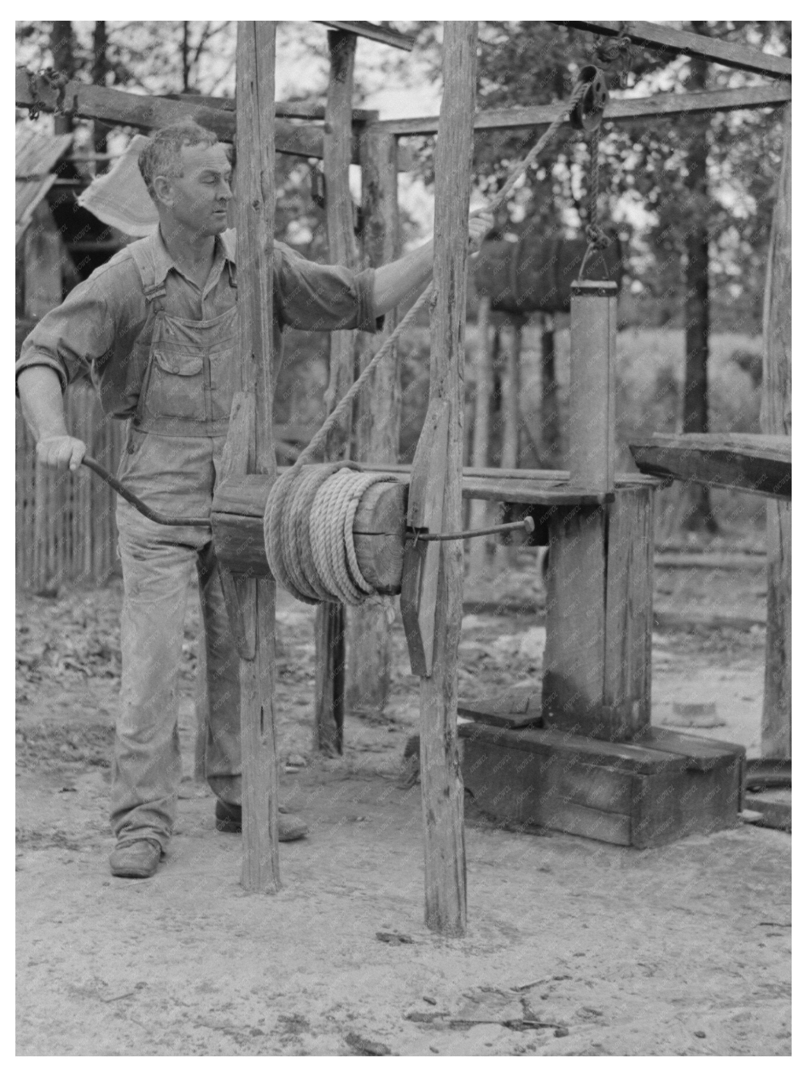 Cut-Over Farmer Drawing Water in Amite Louisiana 1938