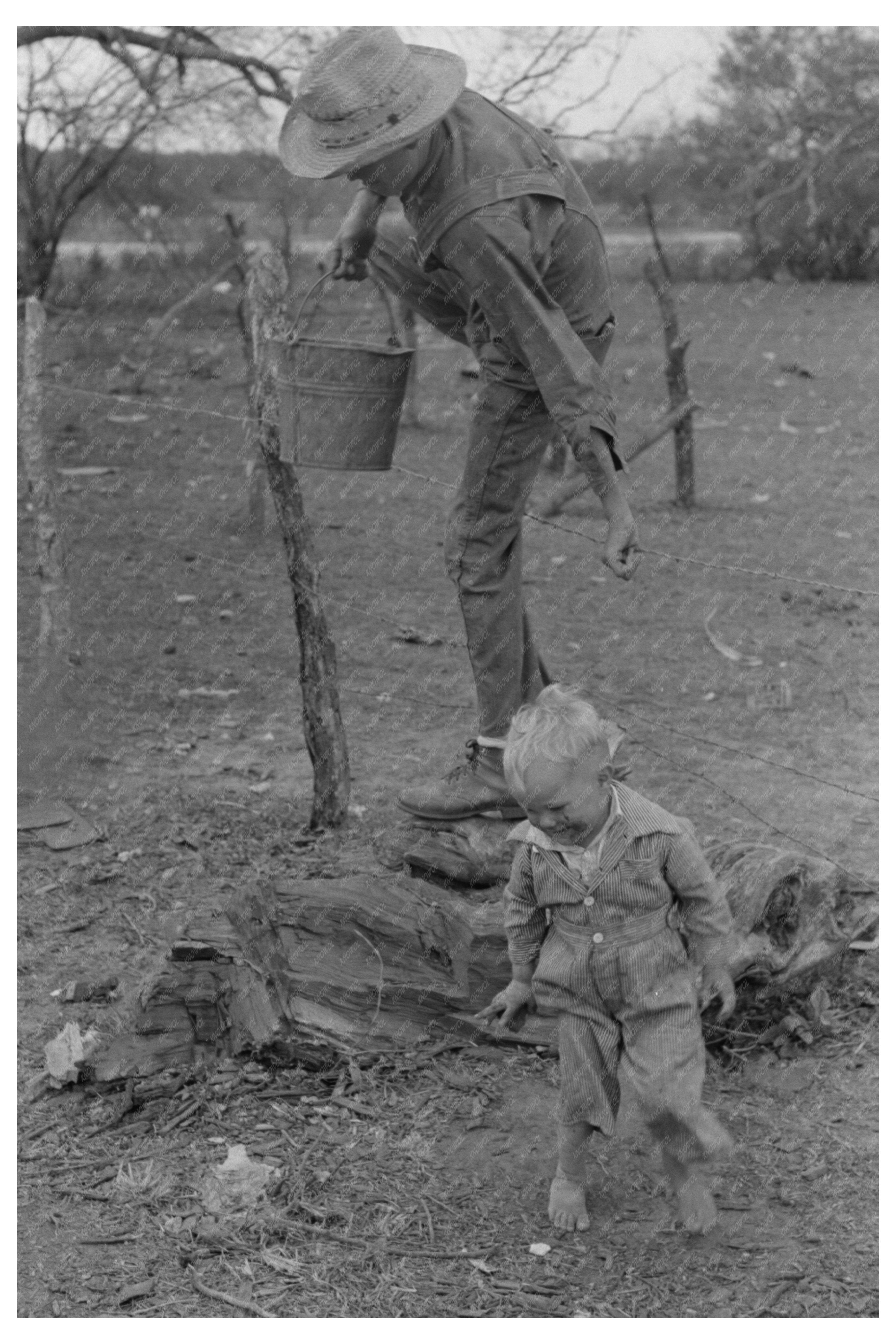 Child Climbing Fence with Water Pail Texas 1939