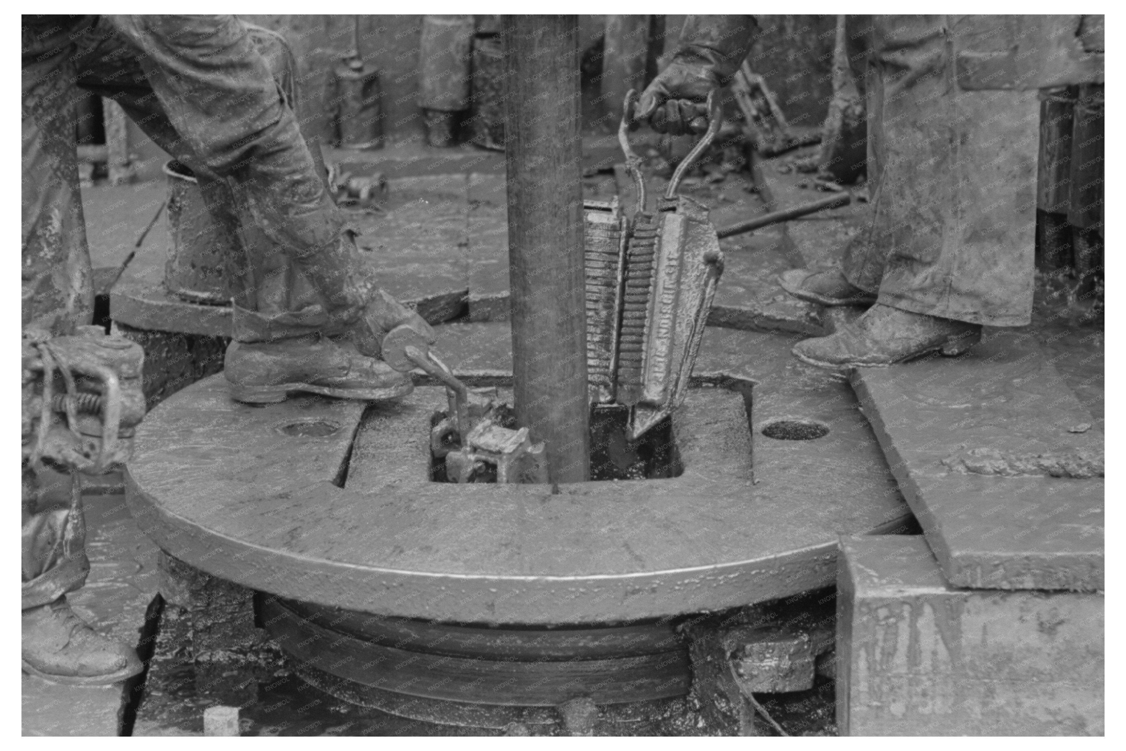 Removing Clamps from Rotary Tackle at Kilgore Oil Well 1939