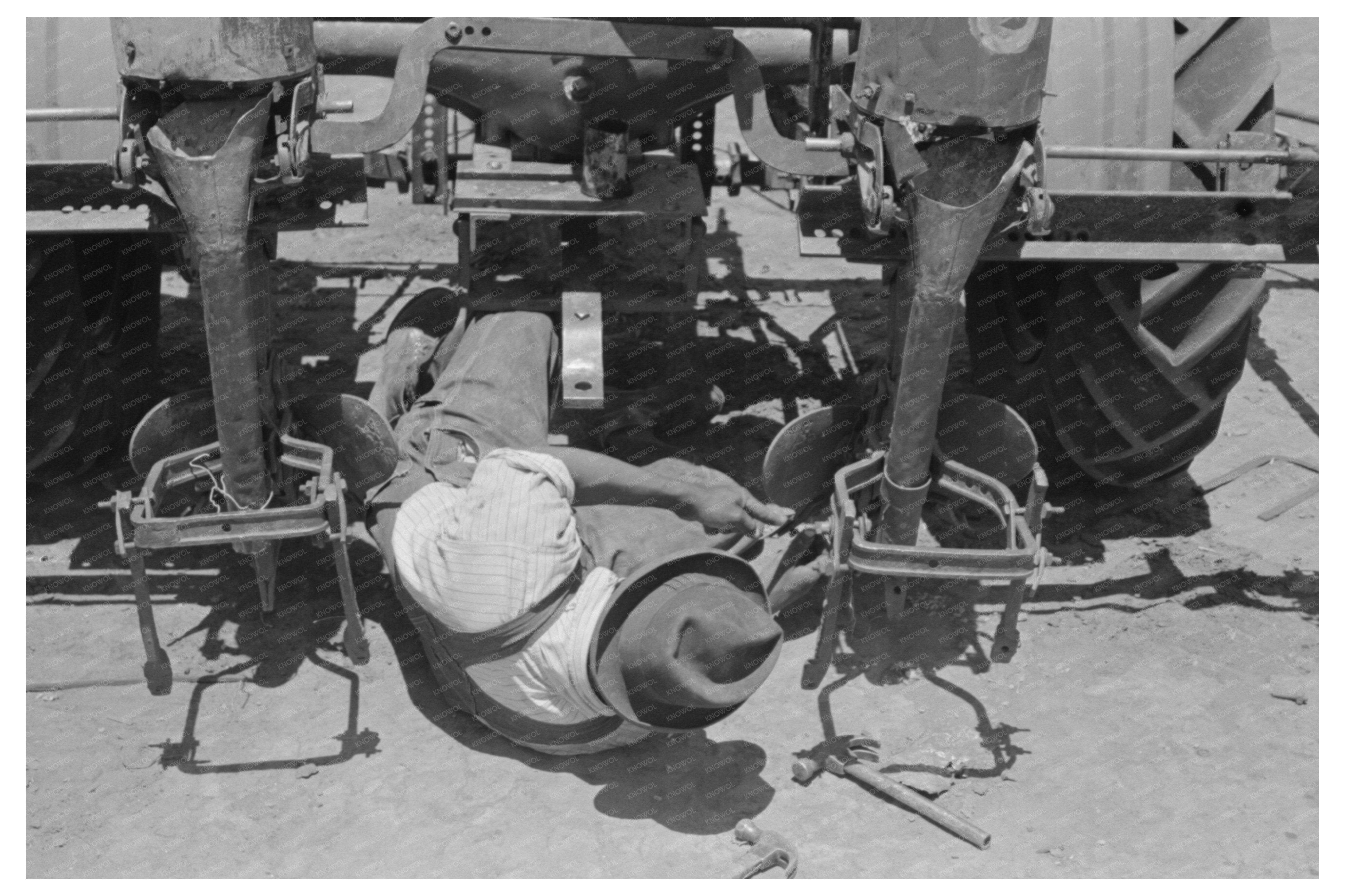 Farmer Adjusting Plow Points on Tractor Planter May 1939