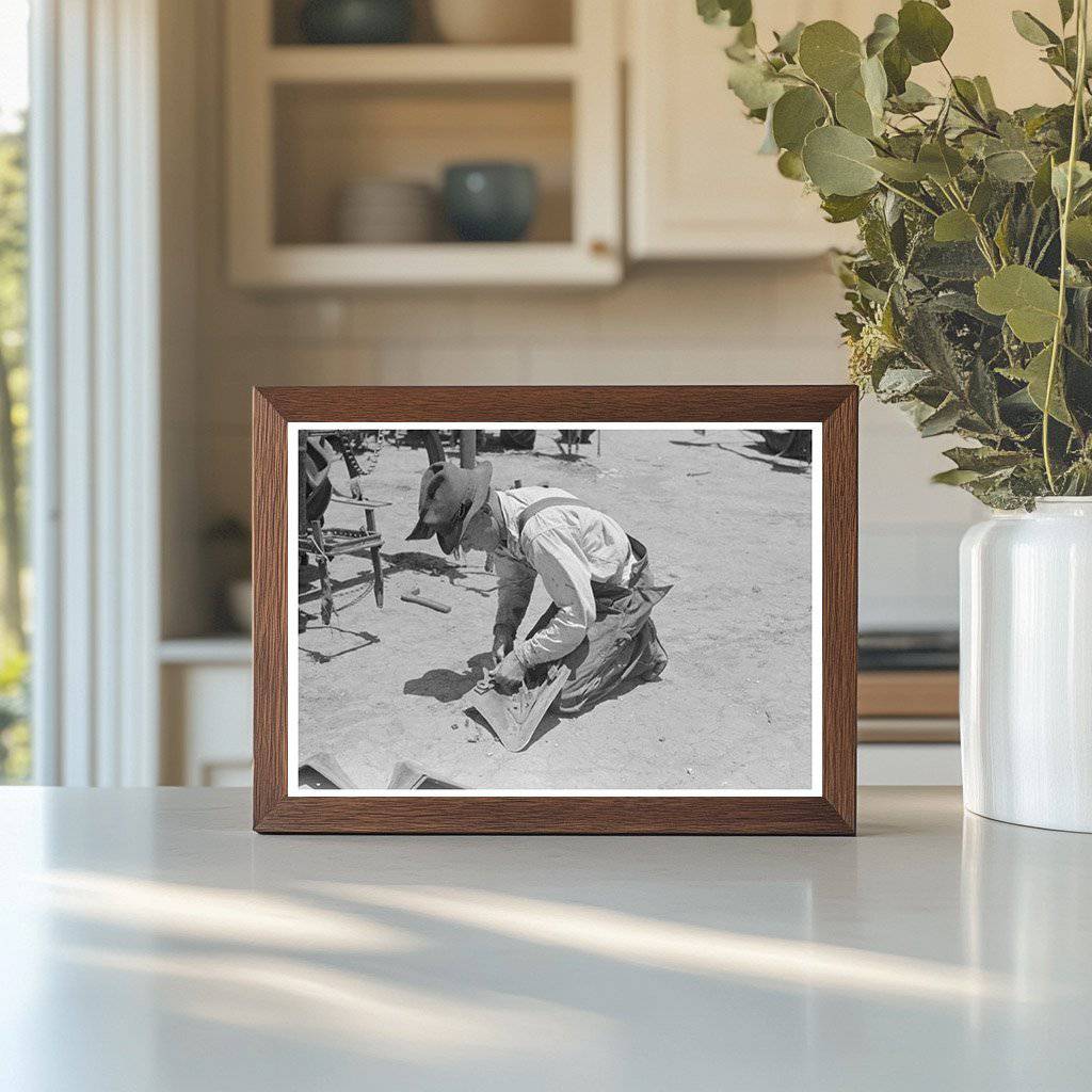 Day Laborer Adjusts Plow Points on Tractor May 1939