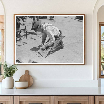 Day Laborer Adjusts Plow Points on Tractor May 1939