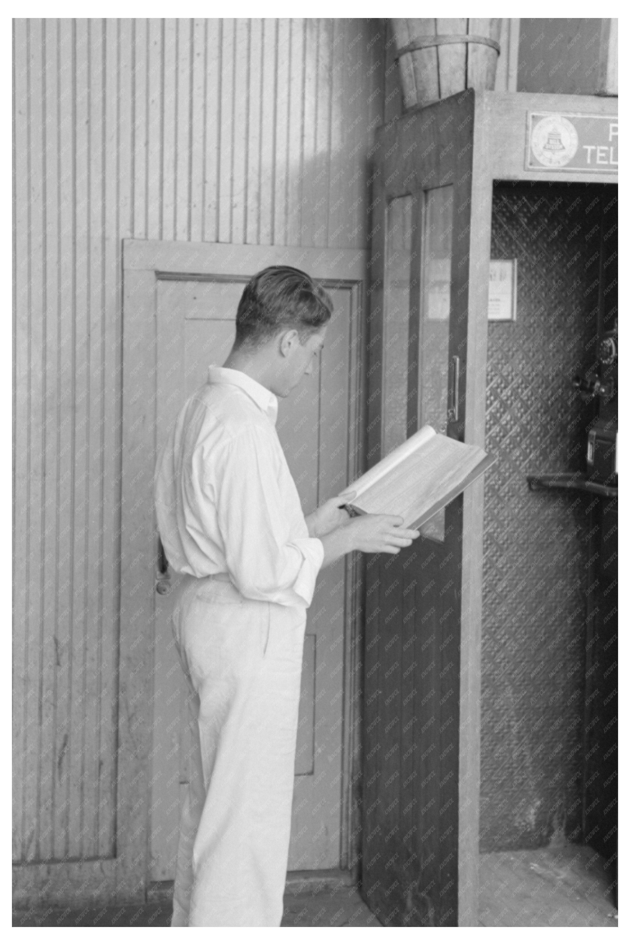 Man Searching Phone Number at Oklahoma City Streetcar Terminal 1939