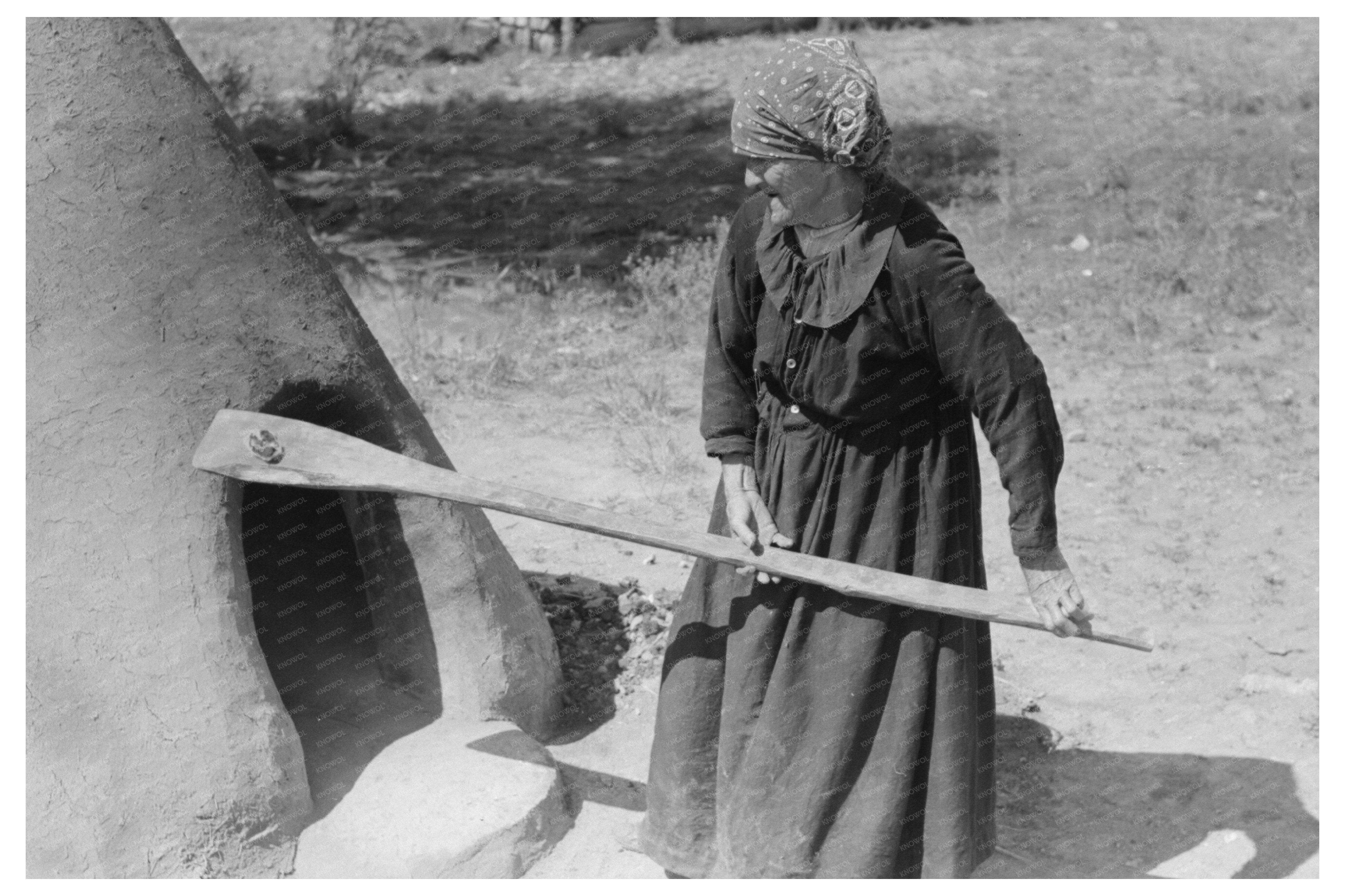 Spanish-American Woman Testing Earthen Oven Temperature 1939