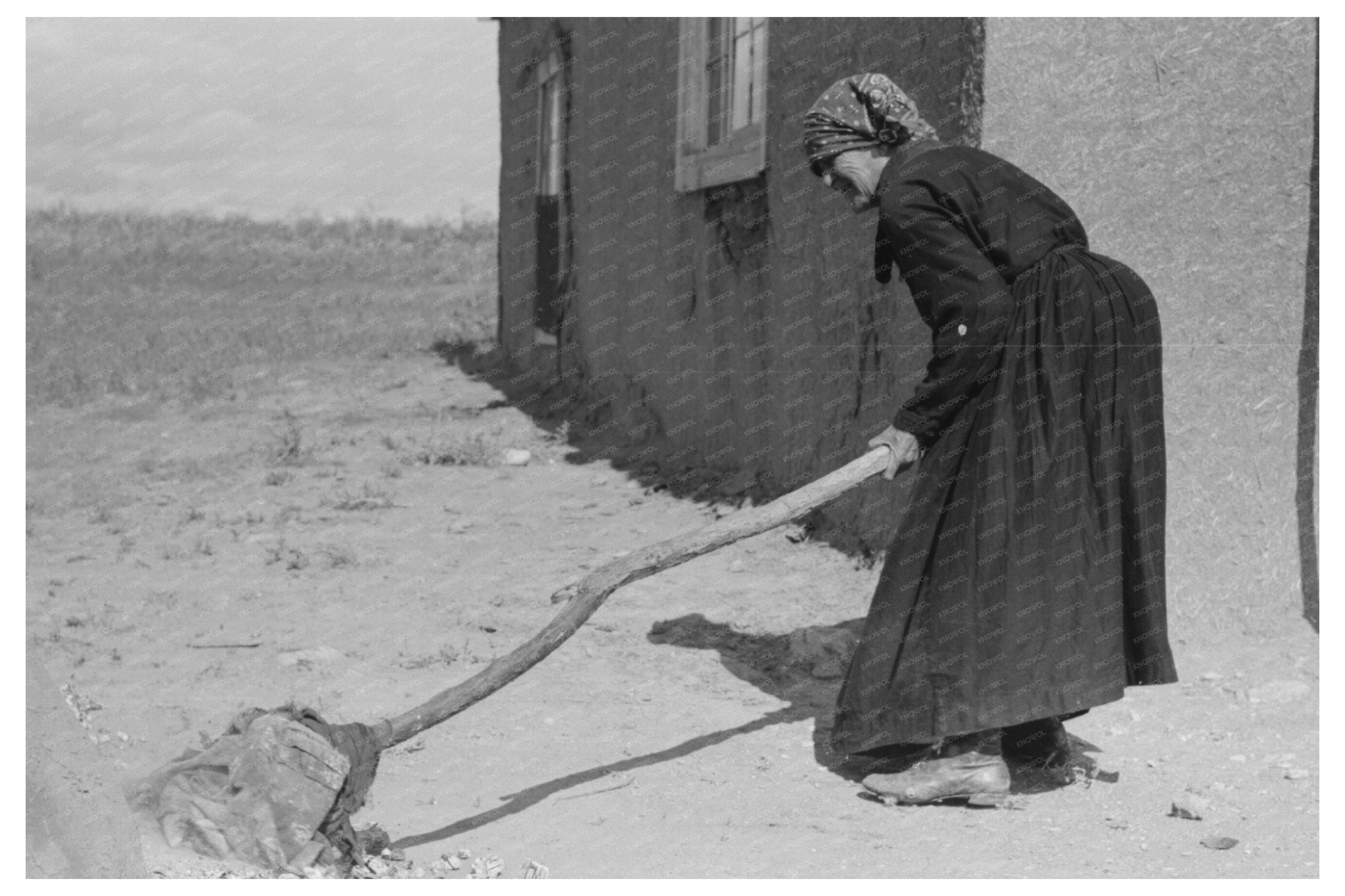 Sweeping Hot Coals from an Outdoor Oven Taos County 1939