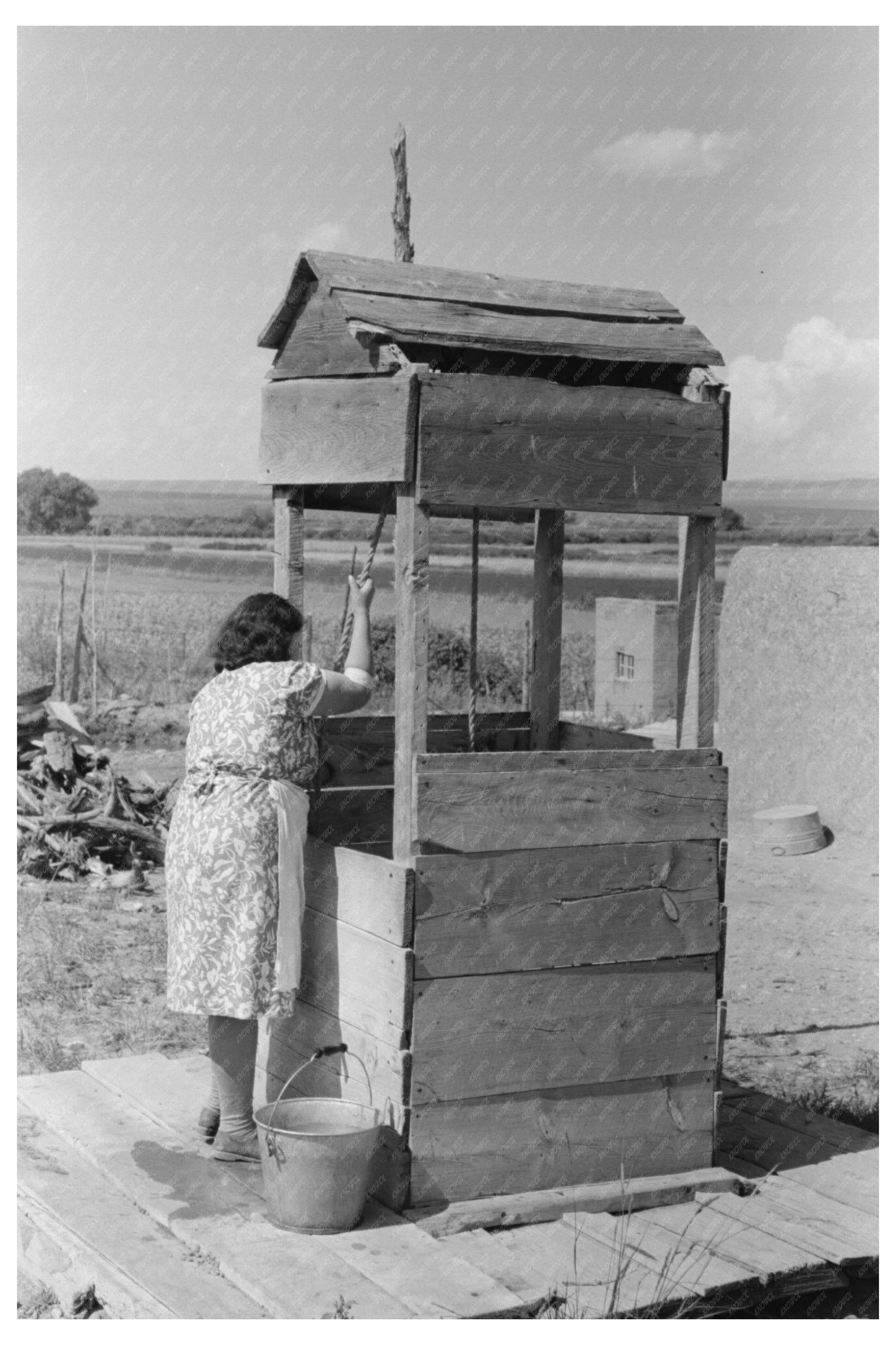 Daughter Drawing Water at Well Taos County 1939