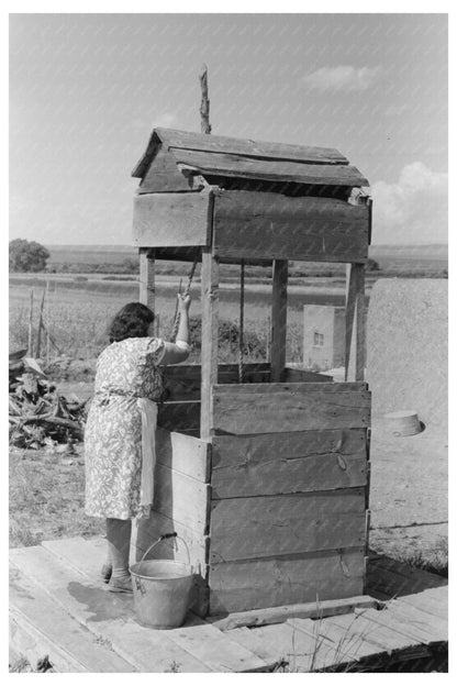 Daughter Drawing Water at Well Taos County 1939